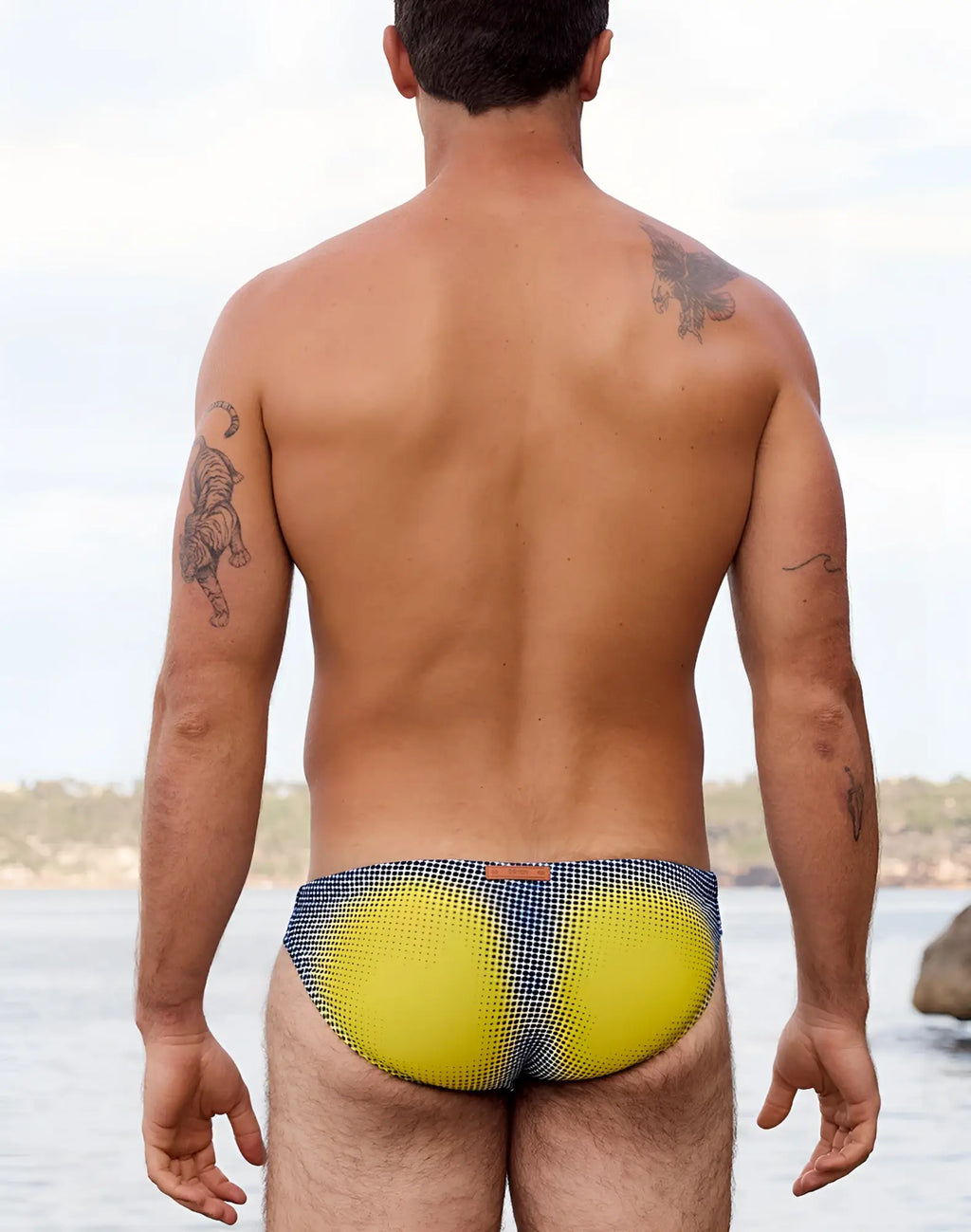 2eros v20 printed swim brief in bright yellow and navy blue checkered pattern with gradient dot design