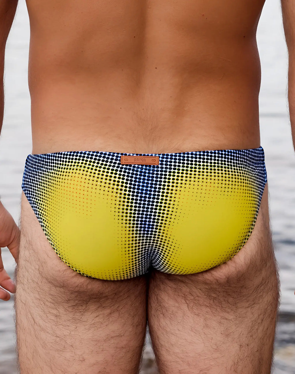 2eros v20 printed swim brief in vibrant yellow and navy blue halftone pattern with brown leather brand tag
