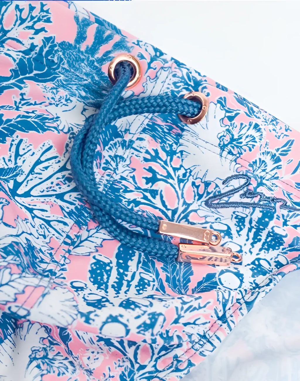 Blue and pink coral-patterned 2EROS V20 printed swim brief with rose gold drawstring hardware in coral teal