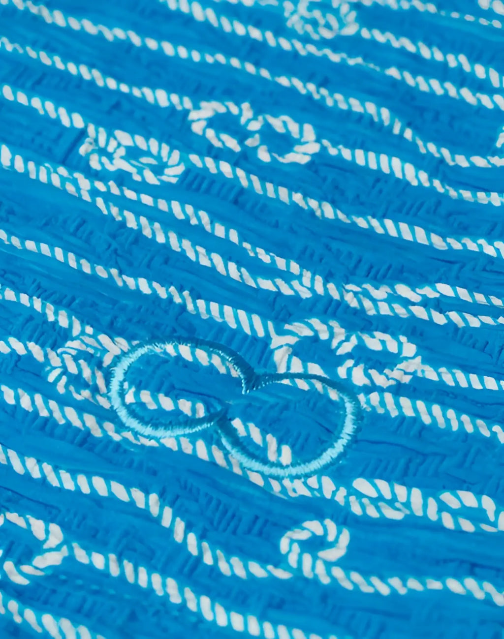 2eros V20 printed swim brief in manrope blue with bright blue fabric white embroidery and central light blue bow design
