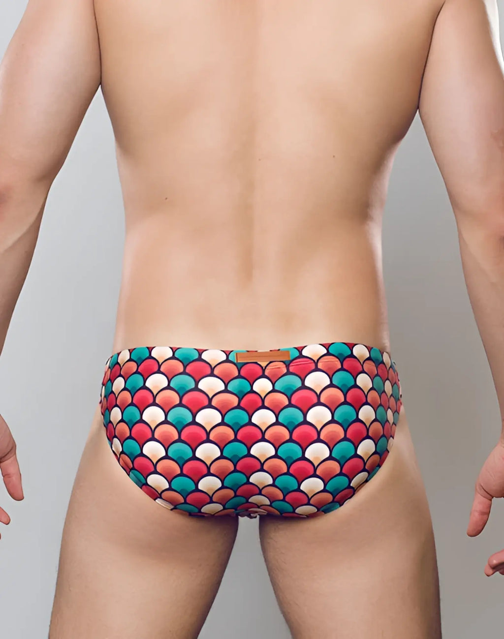 2EROS V20 printed swim brief in retro red with vibrant multicolored bold scale pattern in reds teals and creams