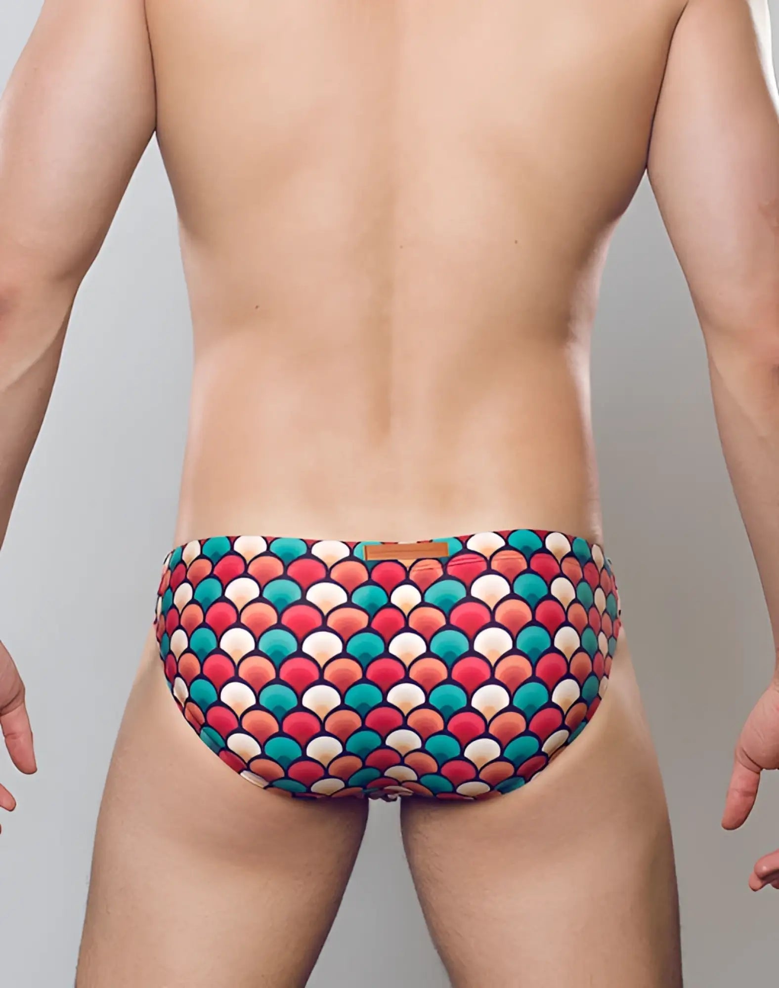 2EROS V20 printed swim brief in retro red with vibrant multicolored bold scale pattern in reds teals and creams