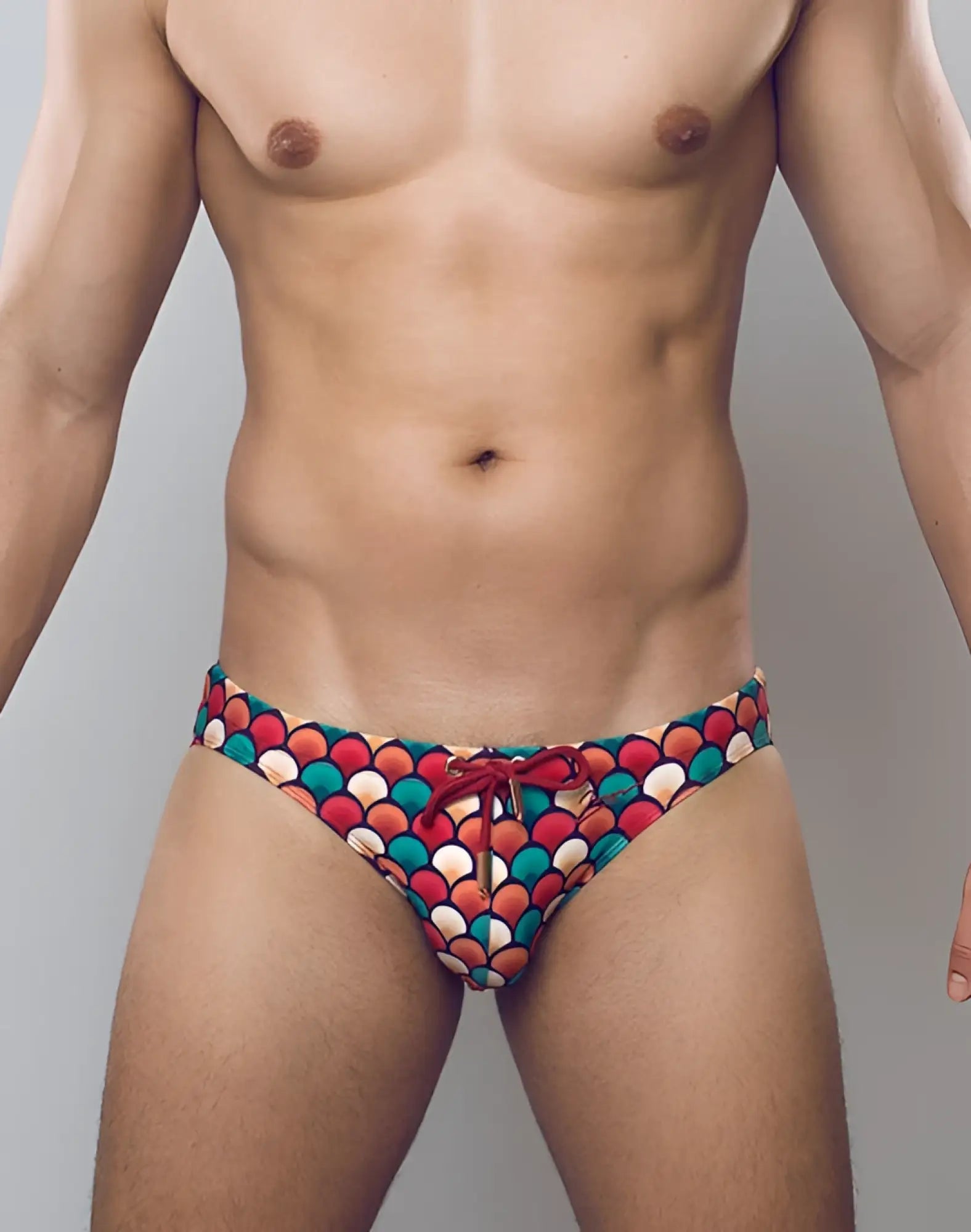 2EROS V20 printed swim brief in retro red features vibrant scalloped pattern with red teal cream colors and matching drawstring waistband