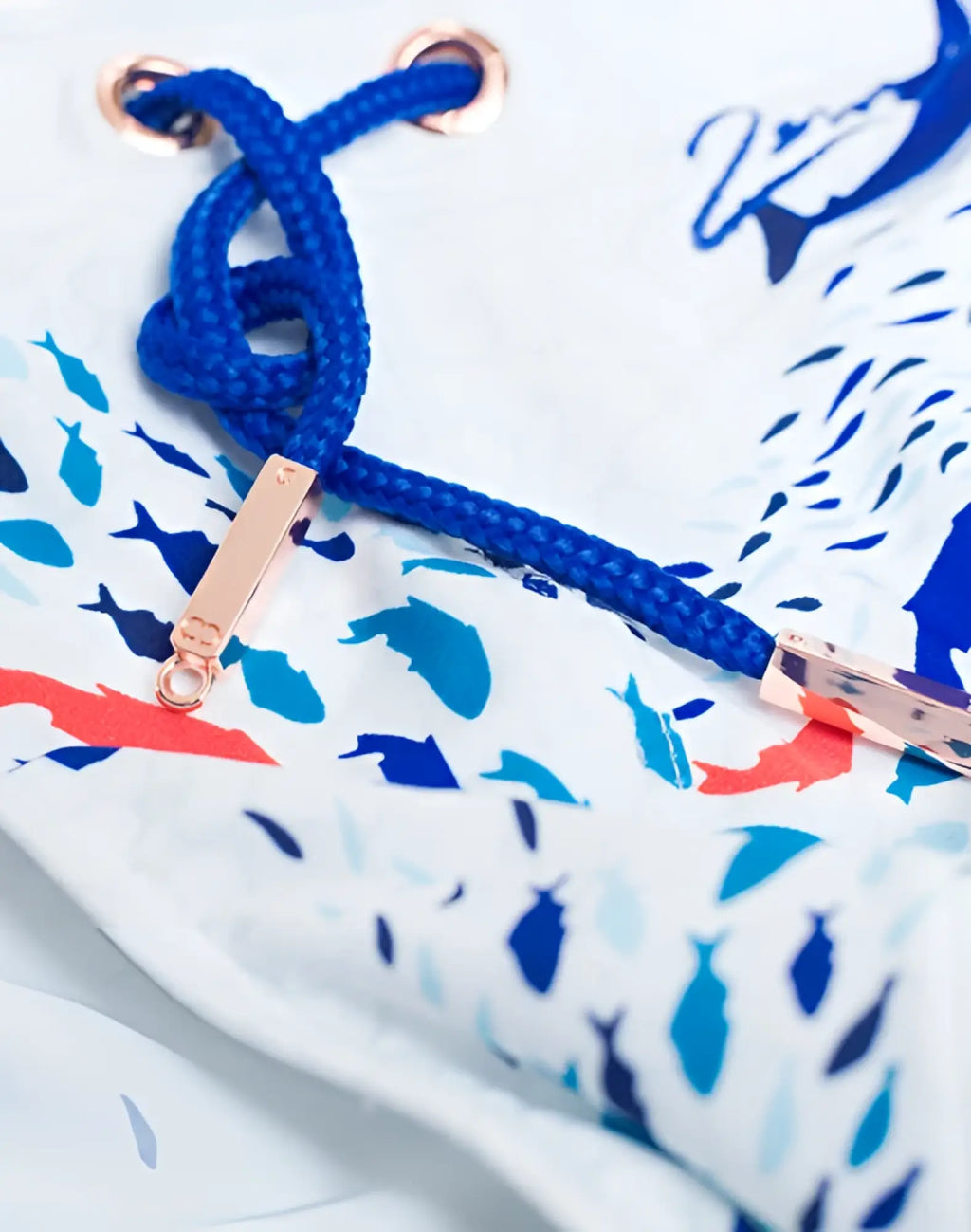 2eros v20 printed swim brief in seascape white with blue rope drawstring and rose gold metal toggles on fish pattern fabric