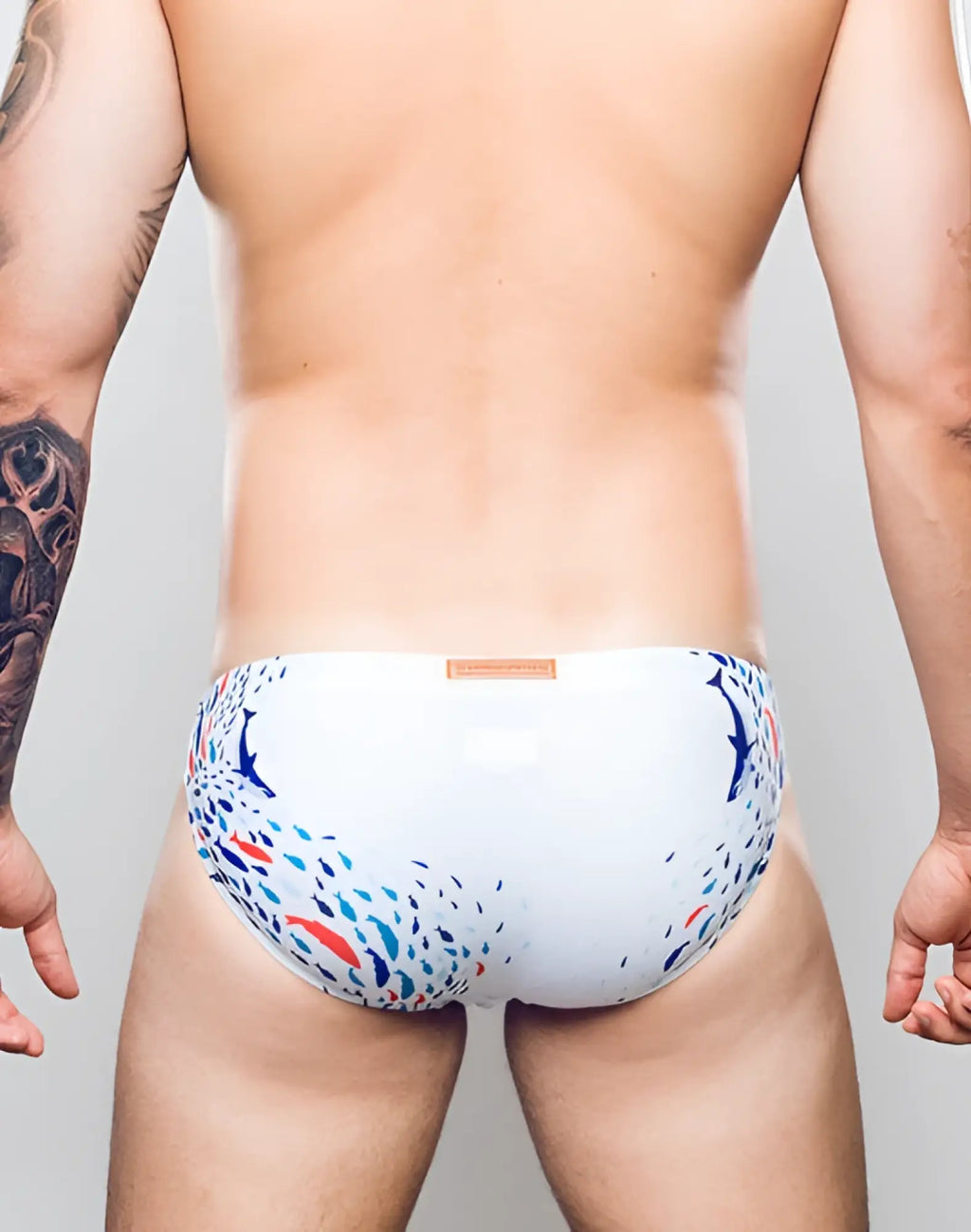 White 2eros v20 printed swim brief with vibrant blue red and black fish pattern ideal for beachwear