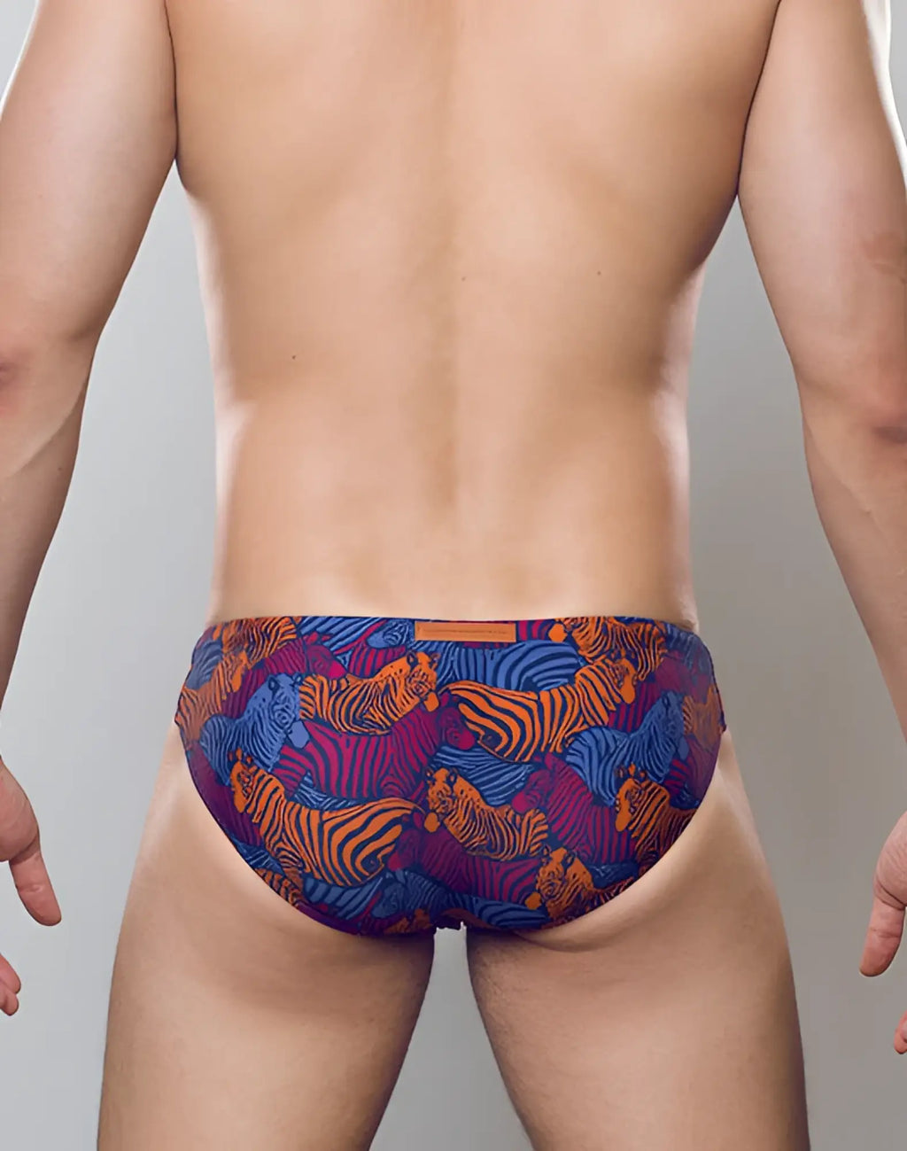 2eros v20 printed swim brief with vibrant orange and blue tiger patterns on a dark purple base for swimwear use