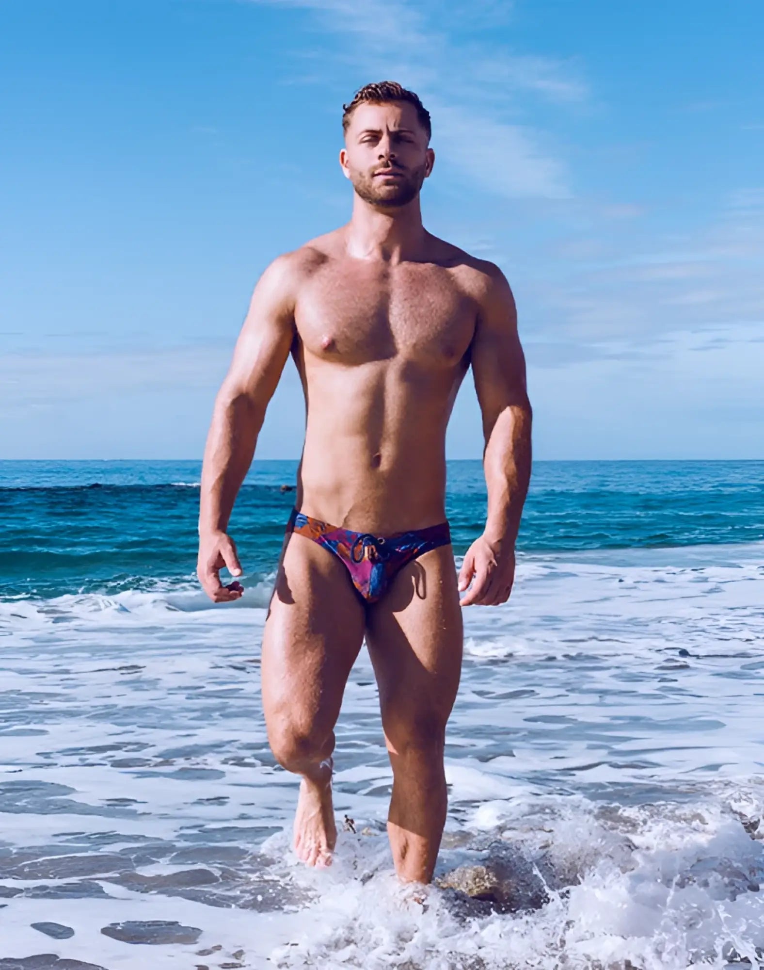 2EROS V20 printed swim brief Stallion Navy featuring vibrant tie-dye patterned trunks in blue red and purple