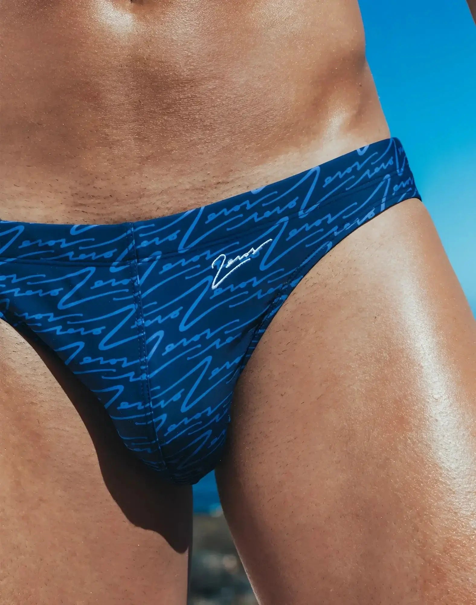 Dark blue 2eros v20 printed swim briefs with a light blue cursive zennor logo pattern for swimming and beachwear