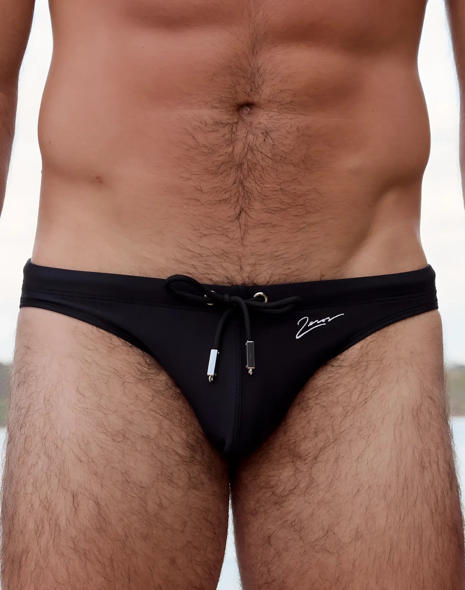 2EROS V20 signature swim brief in black features a drawstring waistband and a white logo on the side