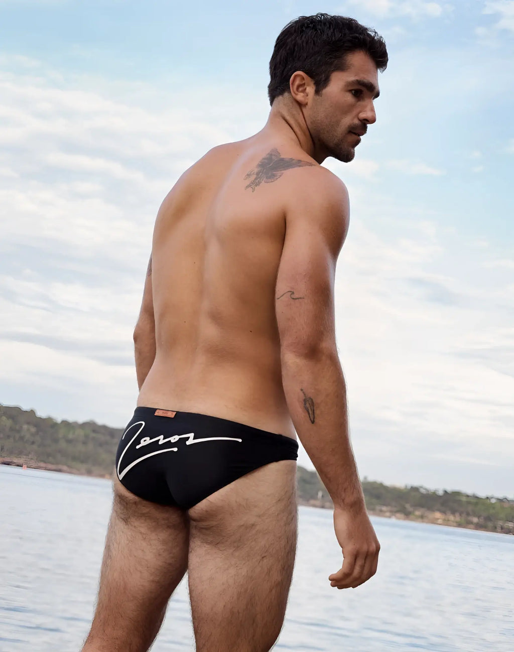 Back view of 2eros v20 signature black swim briefs with white cursive logo on quick-dry fabric