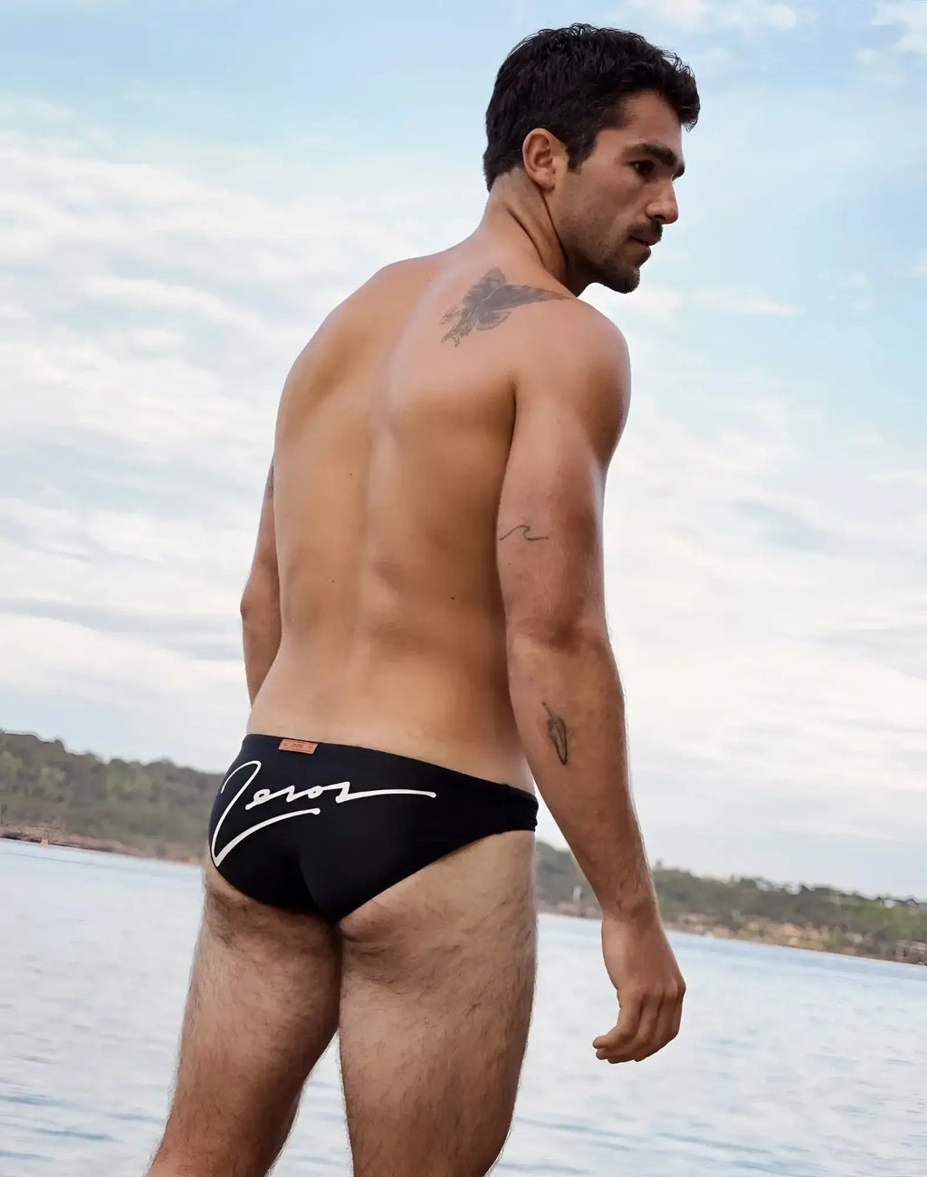 Back view of 2eros v20 signature black swim briefs with white cursive logo on quick-dry fabric