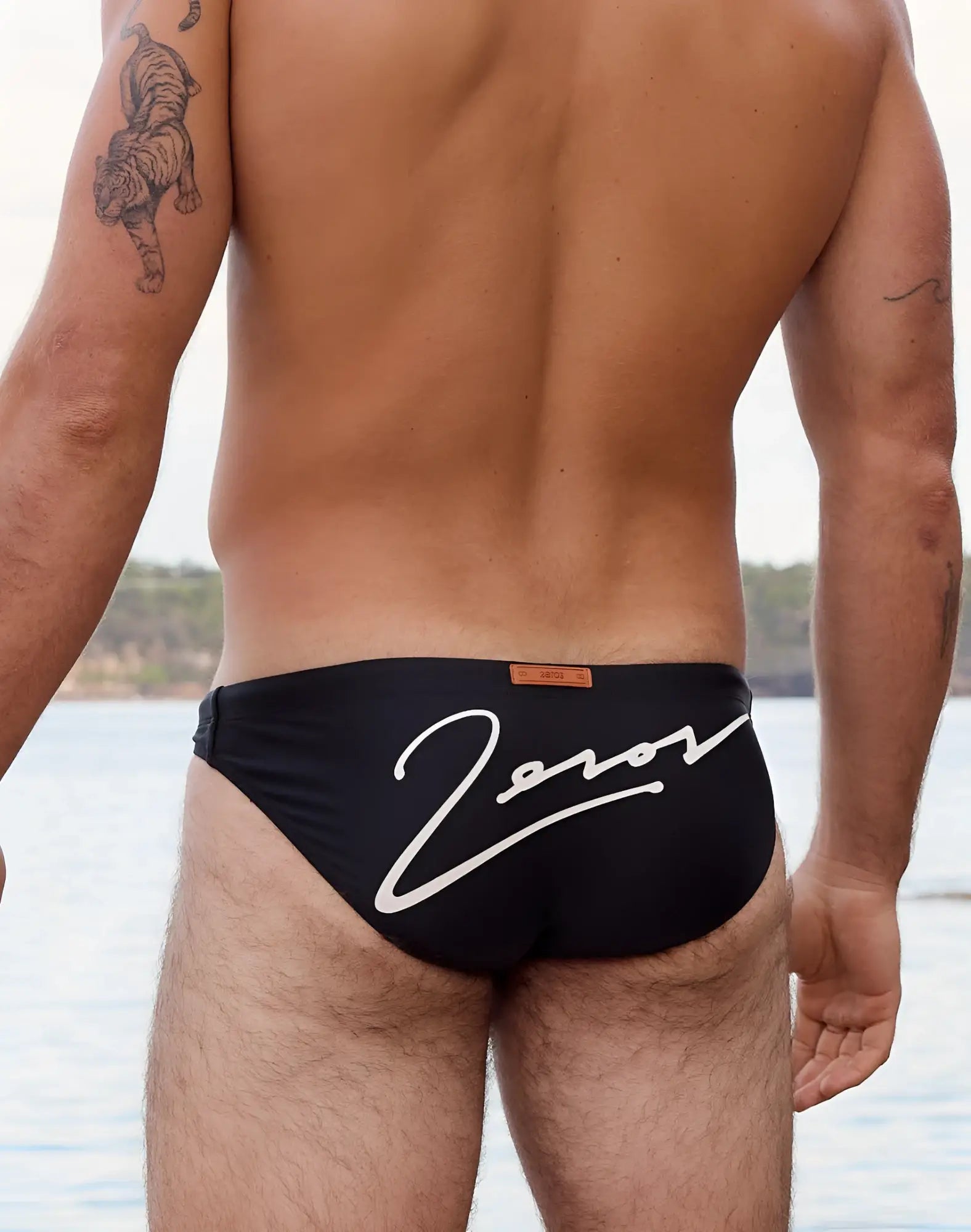2eros v20 signature swim brief in lido black with white zorov branding and small orange tag at the waistband