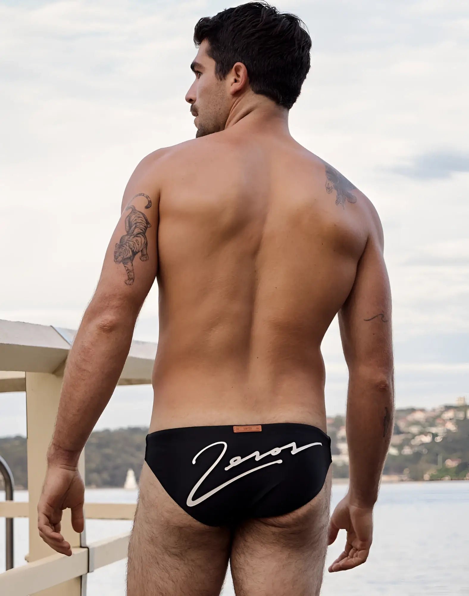 Black 2eros V20 signature swim brief featuring a white cursive zoros logo for stylish swimwear use