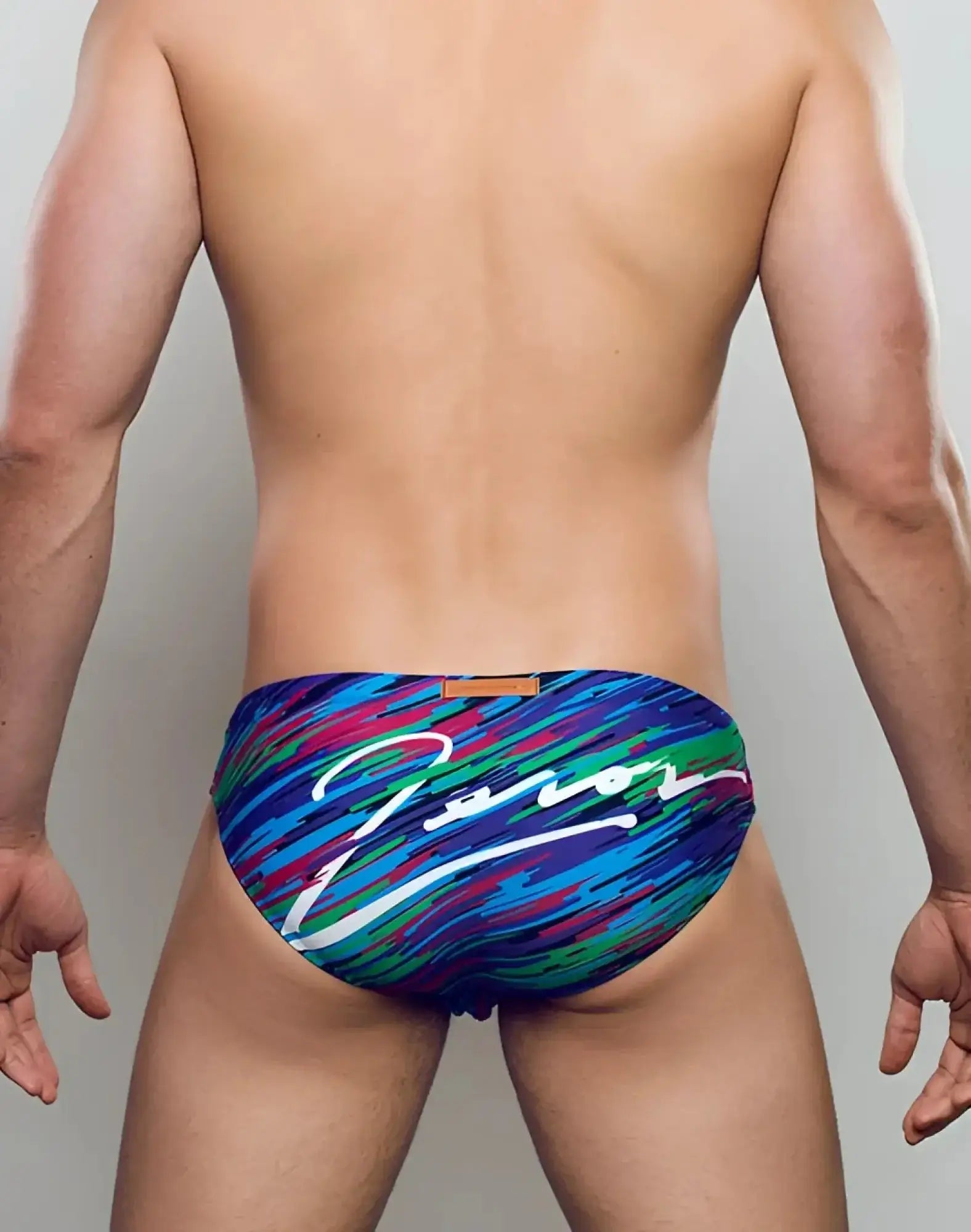 Back side of vibrant multicolored 2EROS V20 signature swim trunks with dynamic brushstroke pattern in flash green by zanor
