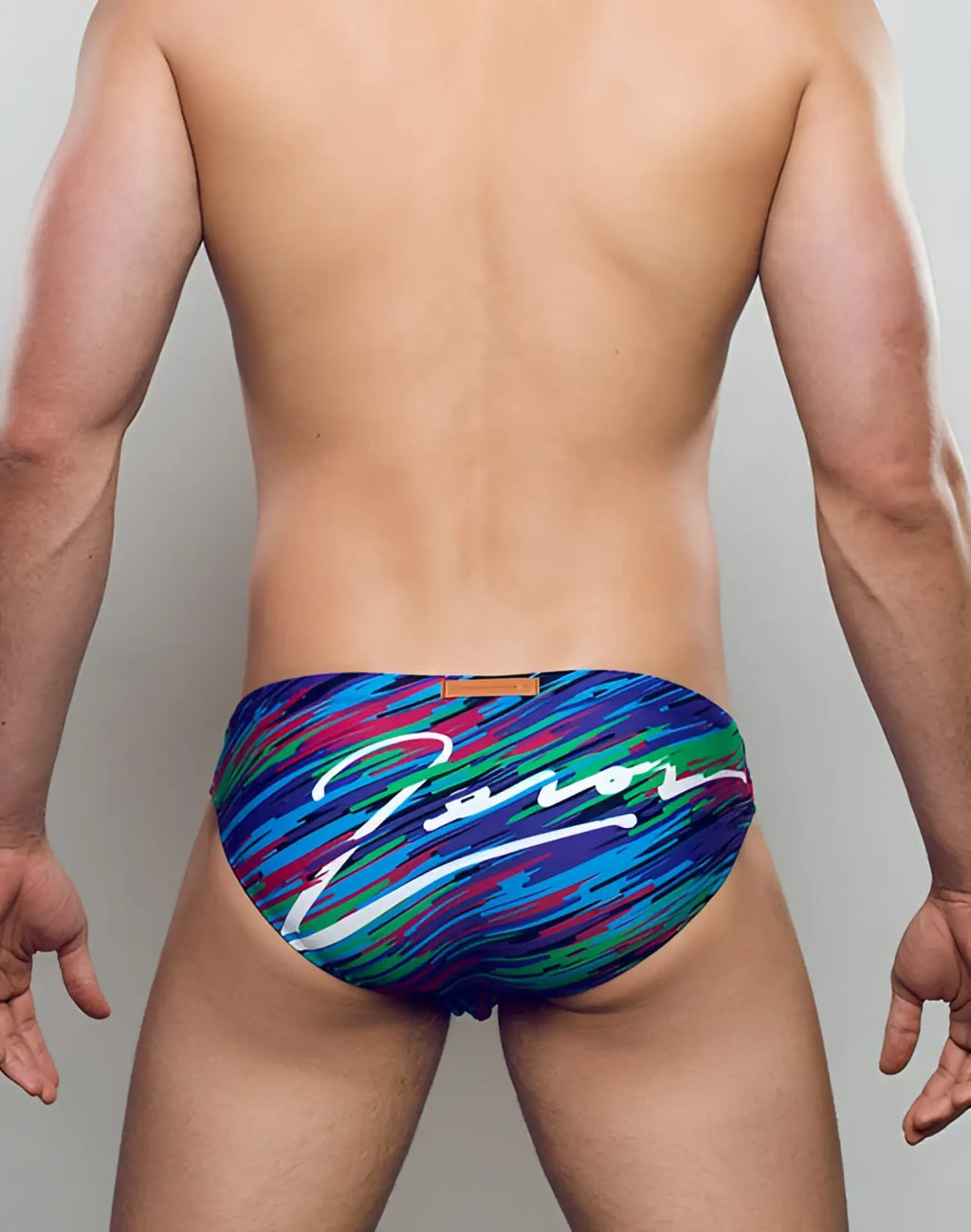 Back side of vibrant multicolored 2EROS V20 signature swim trunks with dynamic brushstroke pattern in flash green by zanor