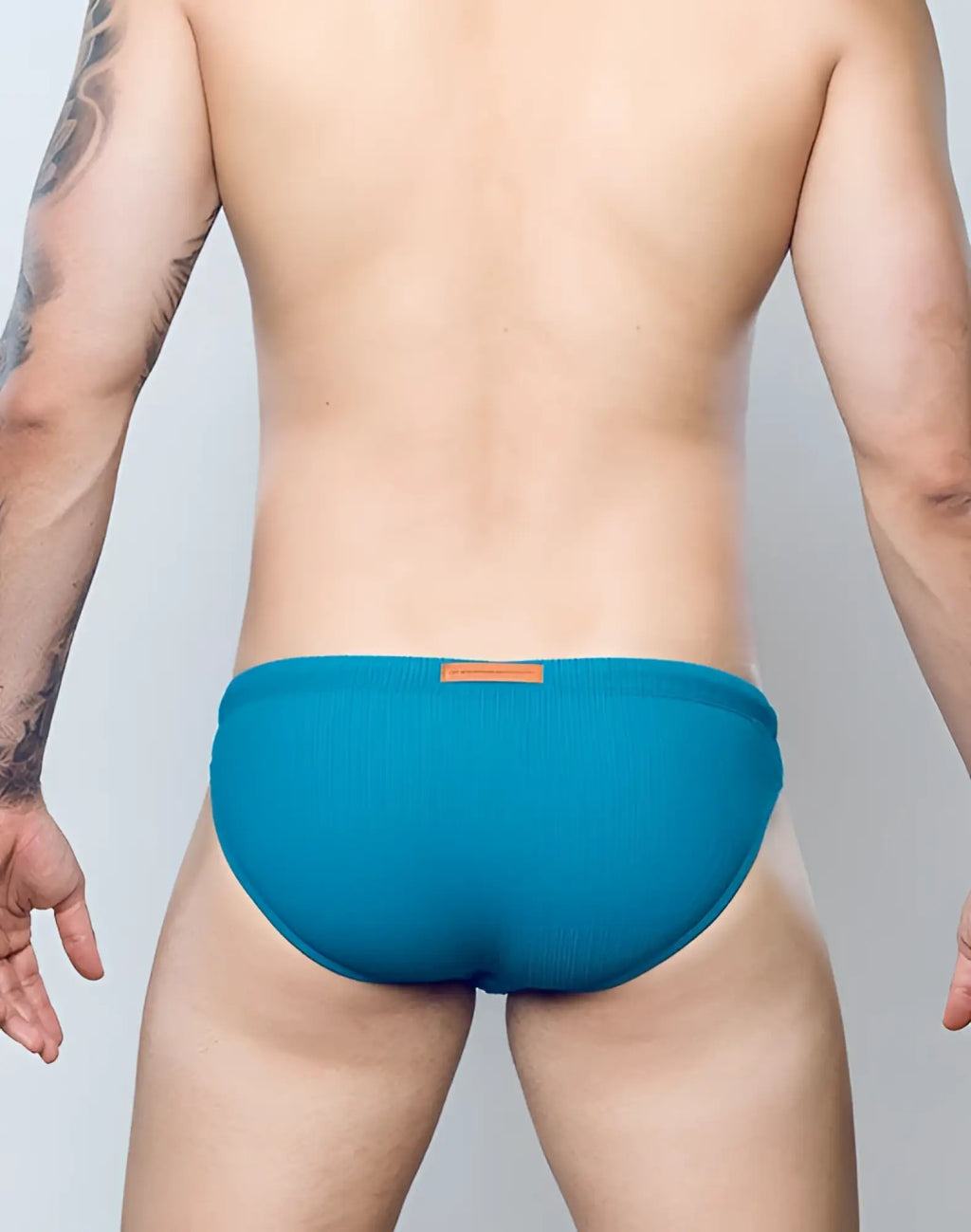 Teal ribbed swim briefs by 2EROS with a small brown leather patch at the waistband in railroad teal color