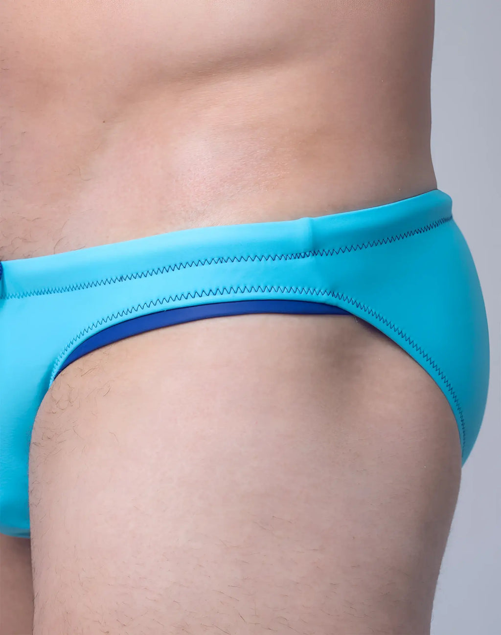 Bright turquoise 2EROS V22 Rapid swim brief with navy inner lining and zigzag stitching on waistband for aquatic wear