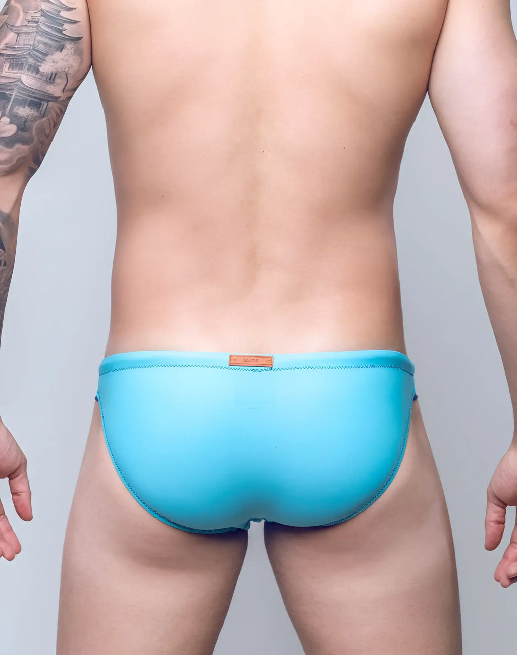 2EROS V22 Rapid swim brief in light blue with subtle stitched trim and brown leather tag at the waistband