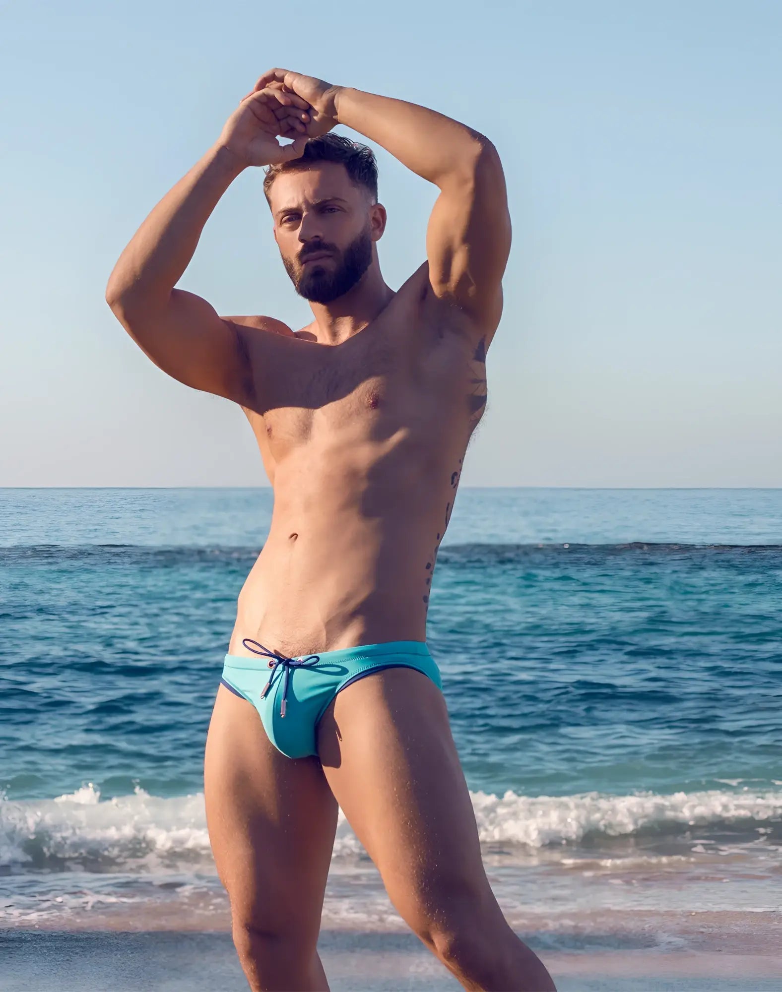 A vibrant turquoise 2EROS V22 rapid swim brief with navy blue drawstring and trim for swimming