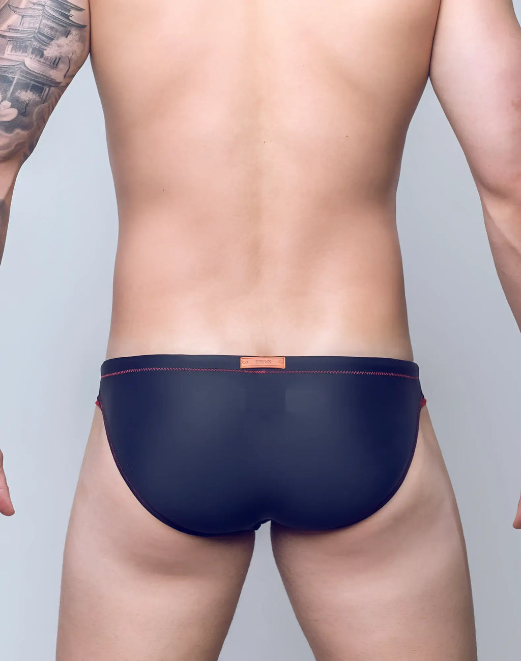 Navy blue 2EROS V22 Rapid swim briefs with red stitching and orange brand tag at the waistband for swimwear use