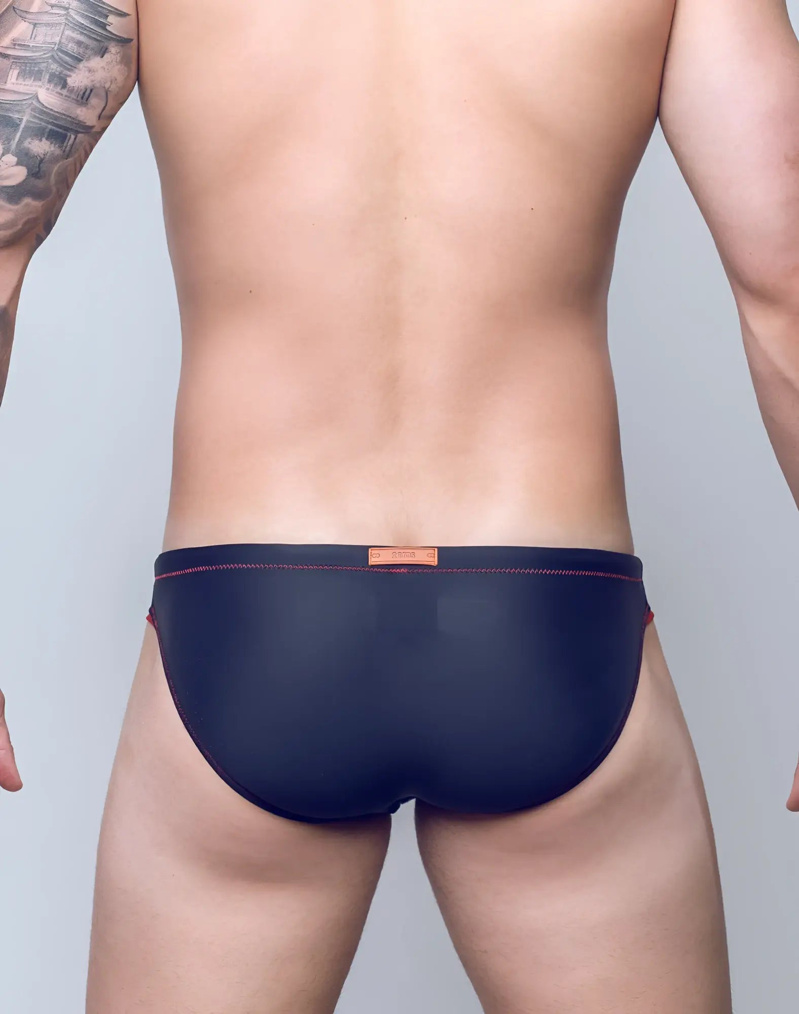 Navy blue 2EROS V22 Rapid swim briefs with red stitching and orange brand tag at the waistband for swimwear use