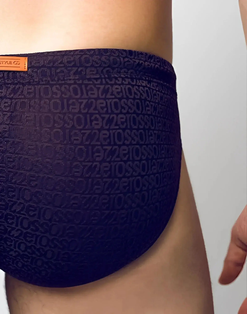 Dark blue 2eros v30 textured swim brief with embossed repeating text pattern on the fabric signet black color