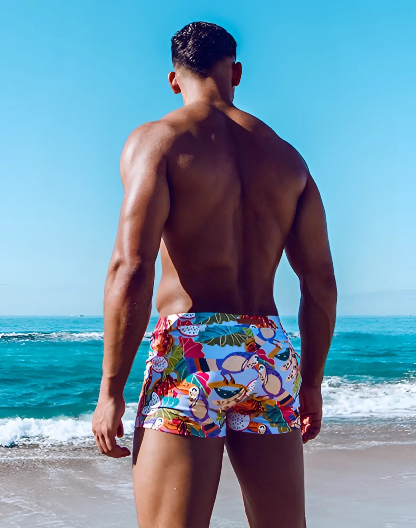 2EROS V60 Bondi print swim trunks in purple with vibrant tropical monkey and fruit motifs on a white base