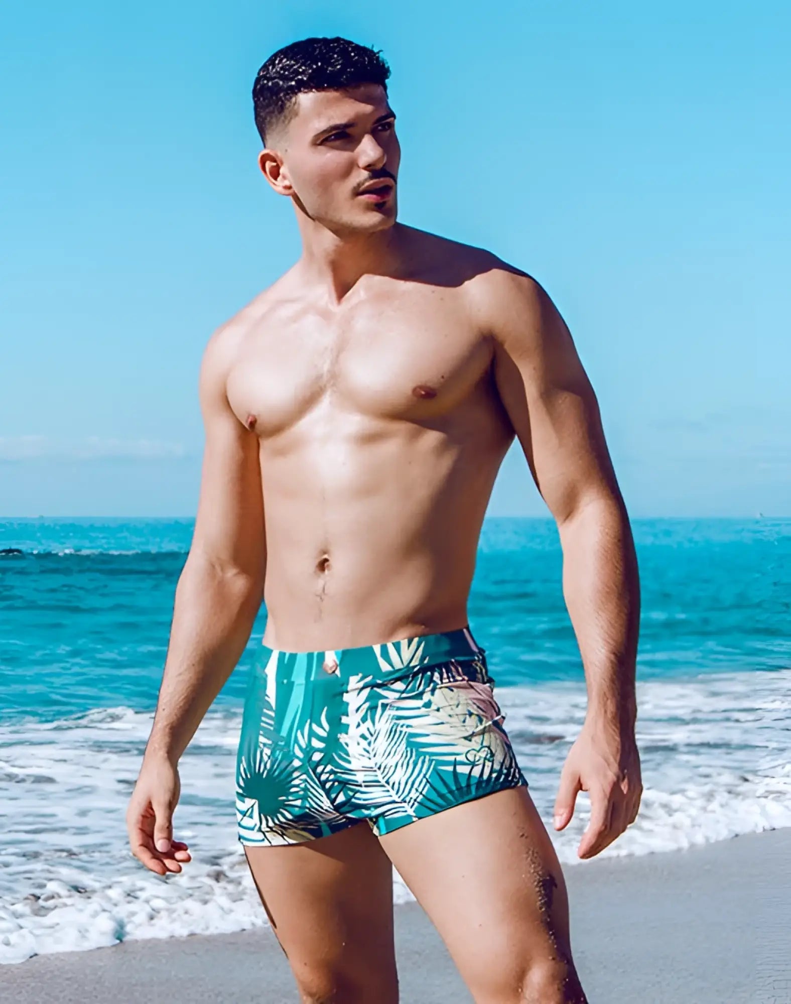 2eros v60 bondi print swim trunks with teal and white tropical leaf pattern designed for swimming and beachwear