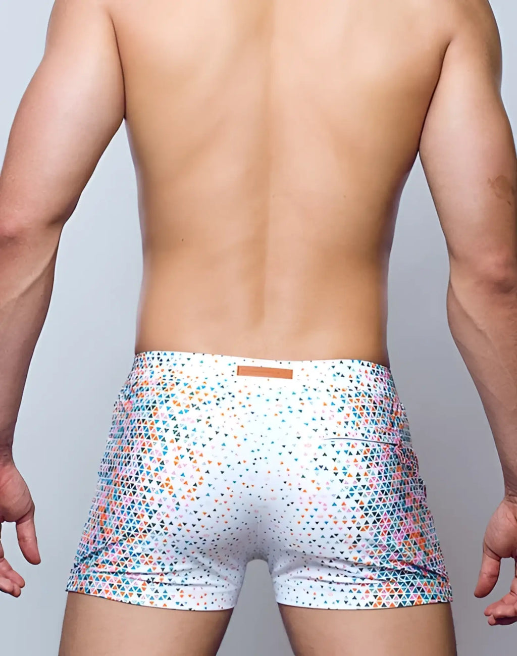 White 2EROS V60 Bondi print swim trunks with vibrant teal pink and orange triangle pattern for beachwear