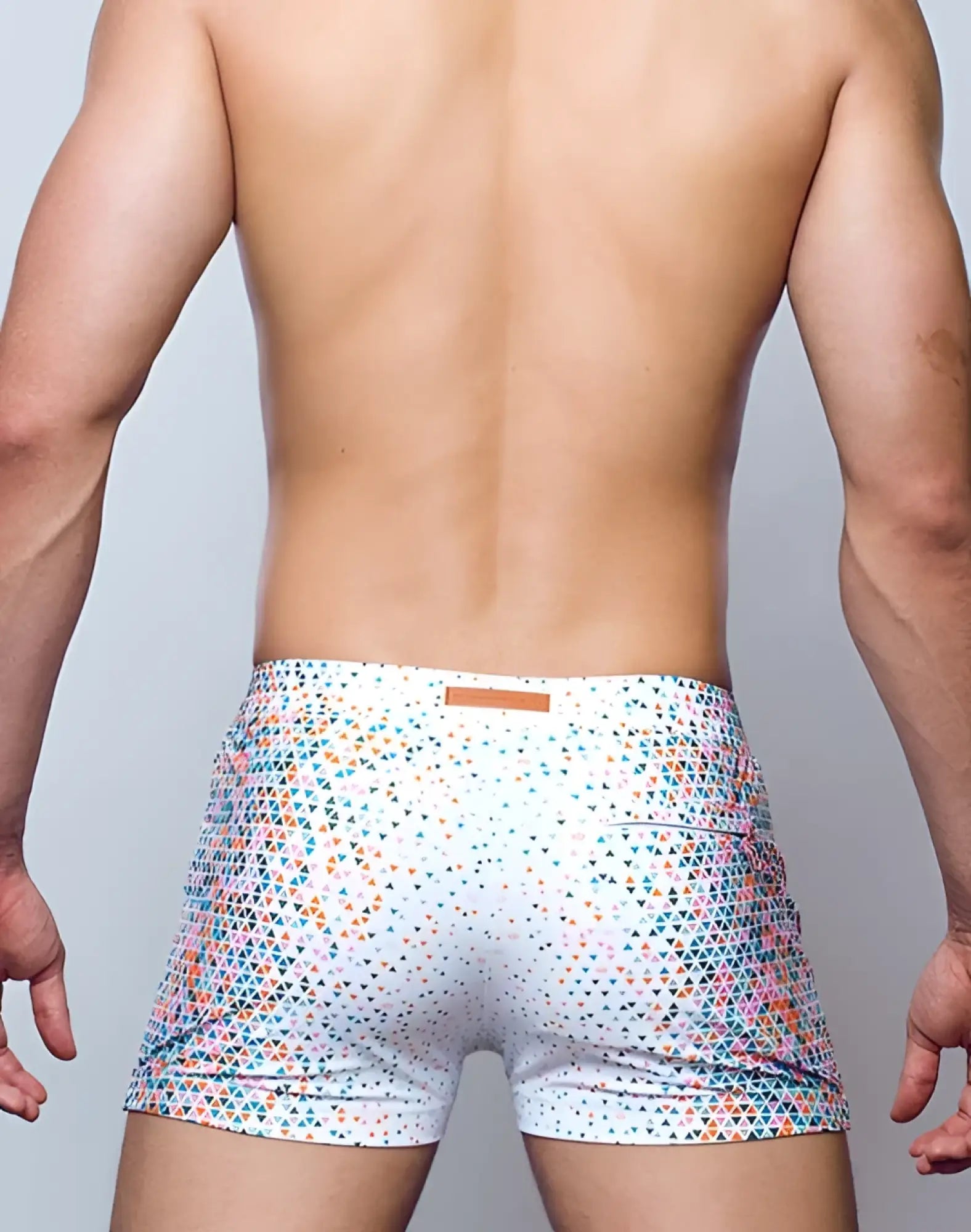 White 2EROS V60 Bondi print swim trunks with vibrant teal pink and orange triangle pattern for beachwear