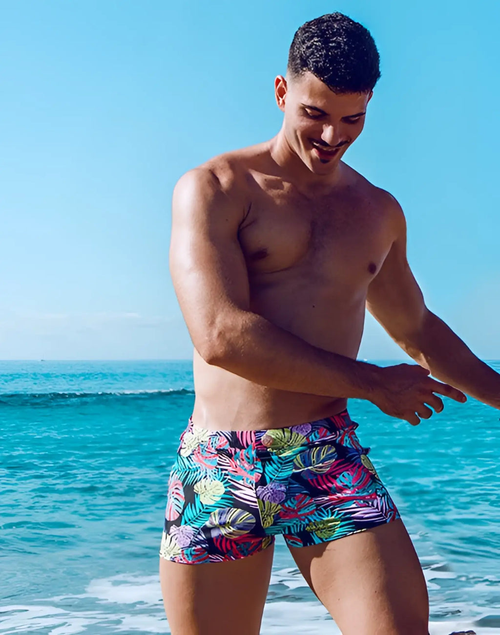 2eros v60 bondi print swim trunks with vibrant pink teal and green monstera leaf pattern on black base