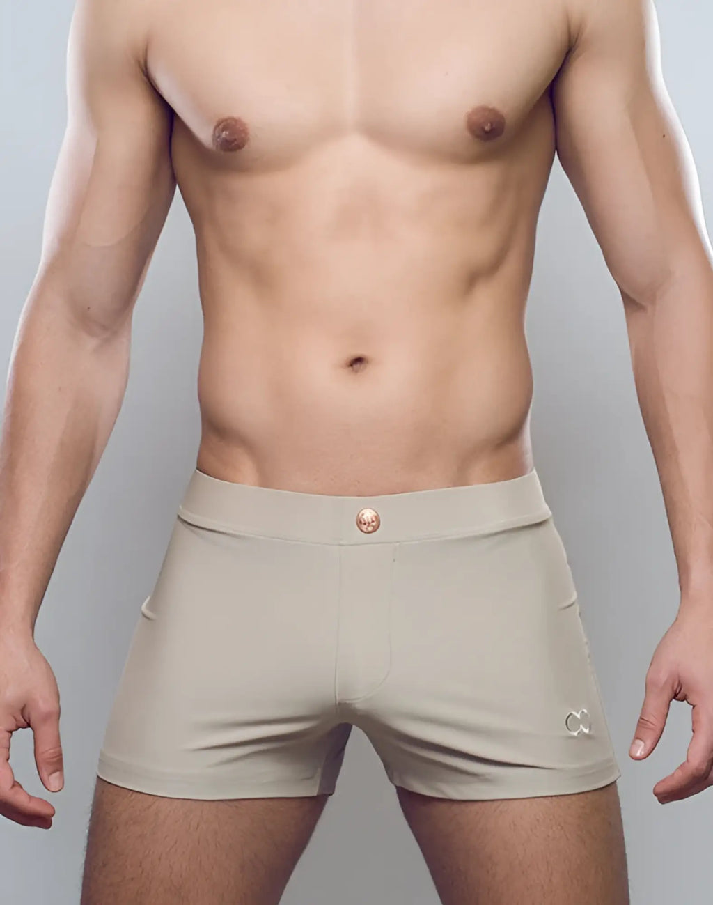 Taupe 2eros v60 bondi series 1 swim trunks featuring beige briefs with gold-toned button and embroidered logo