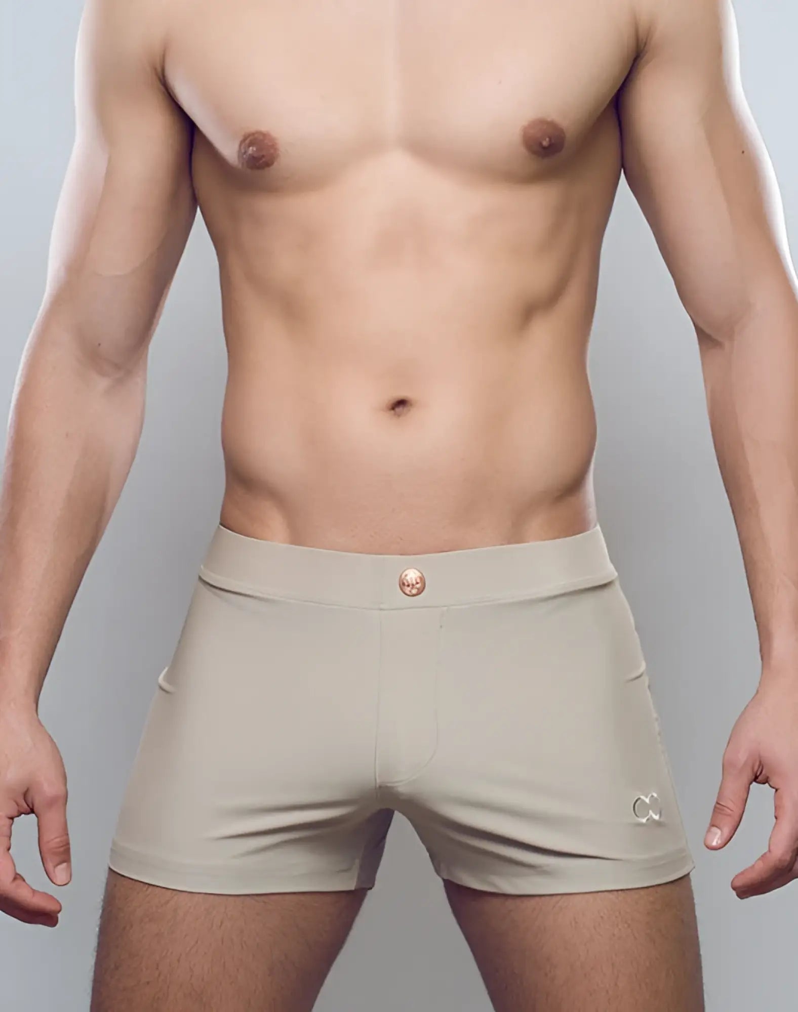 Taupe 2eros v60 bondi series 1 swim trunks featuring beige briefs with gold-toned button and embroidered logo