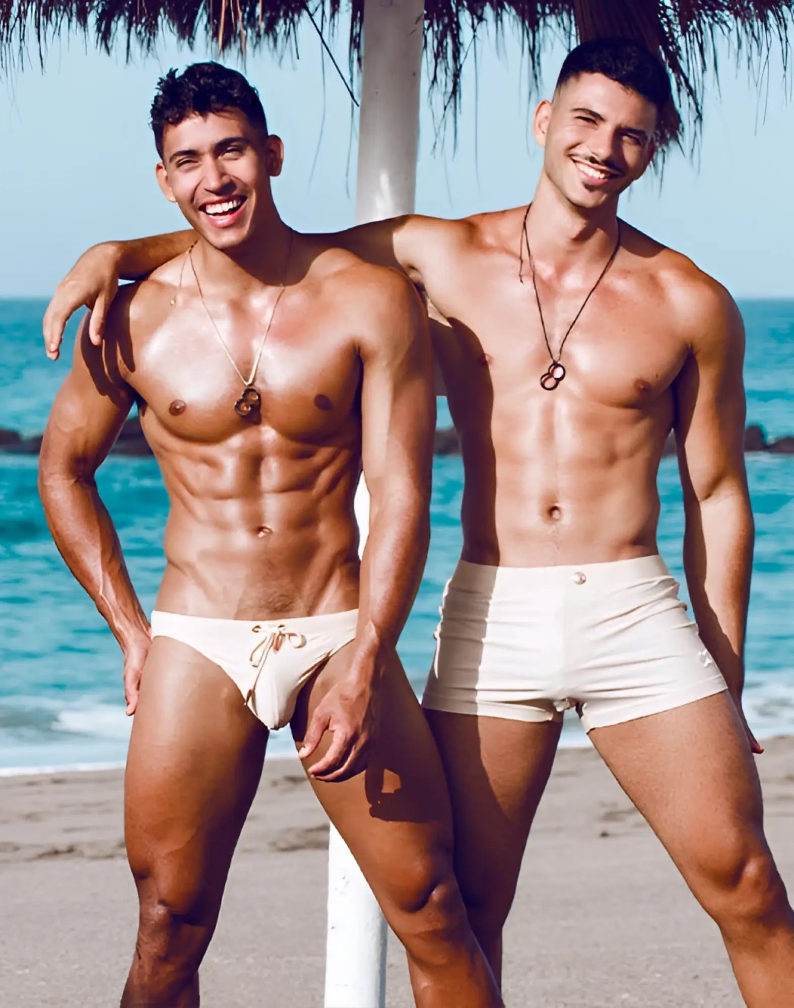 Men wearing 2EROS V60 Bondi series 2 swim trunks in sand with a minimalist cream-colored design
