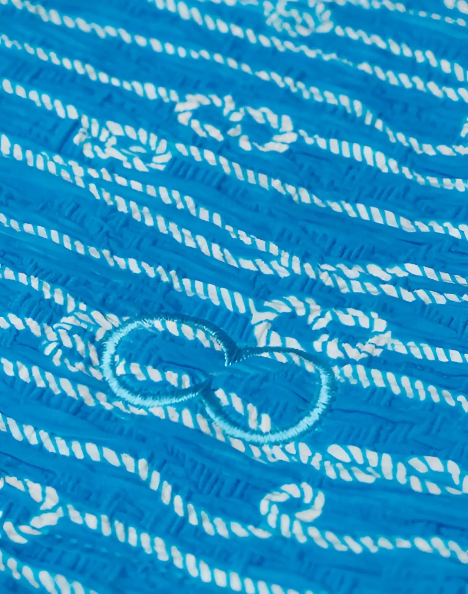 2EROS V60 print swim trunks in Manrope blue with bright blue fabric, white embroidery, and a light-blue central bow design