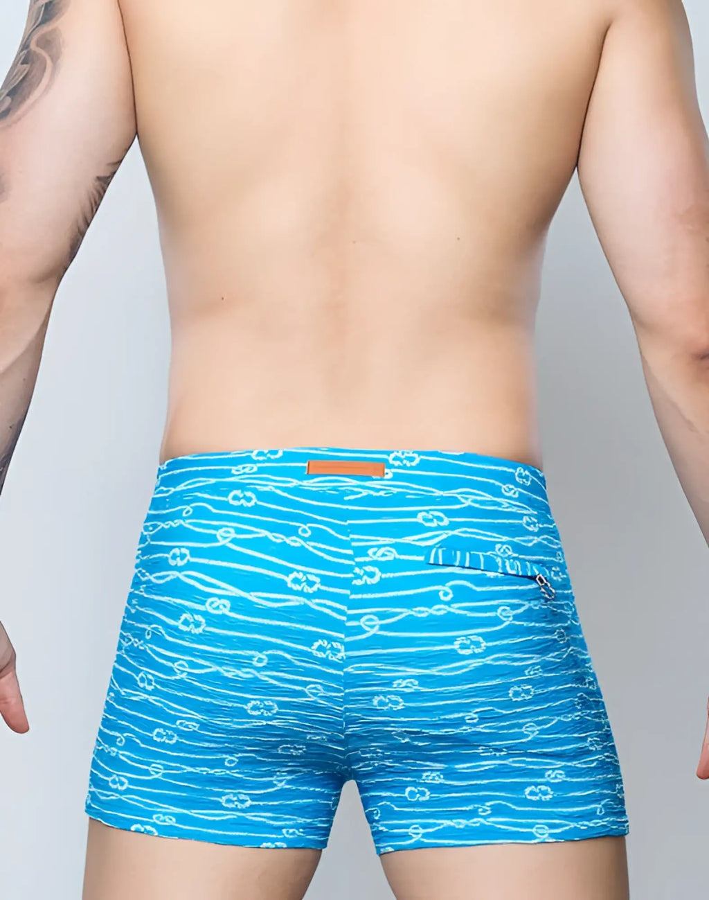 Bright blue 2EROS v60 swim trunks with white rope and anchor print designed for men’s beachwear