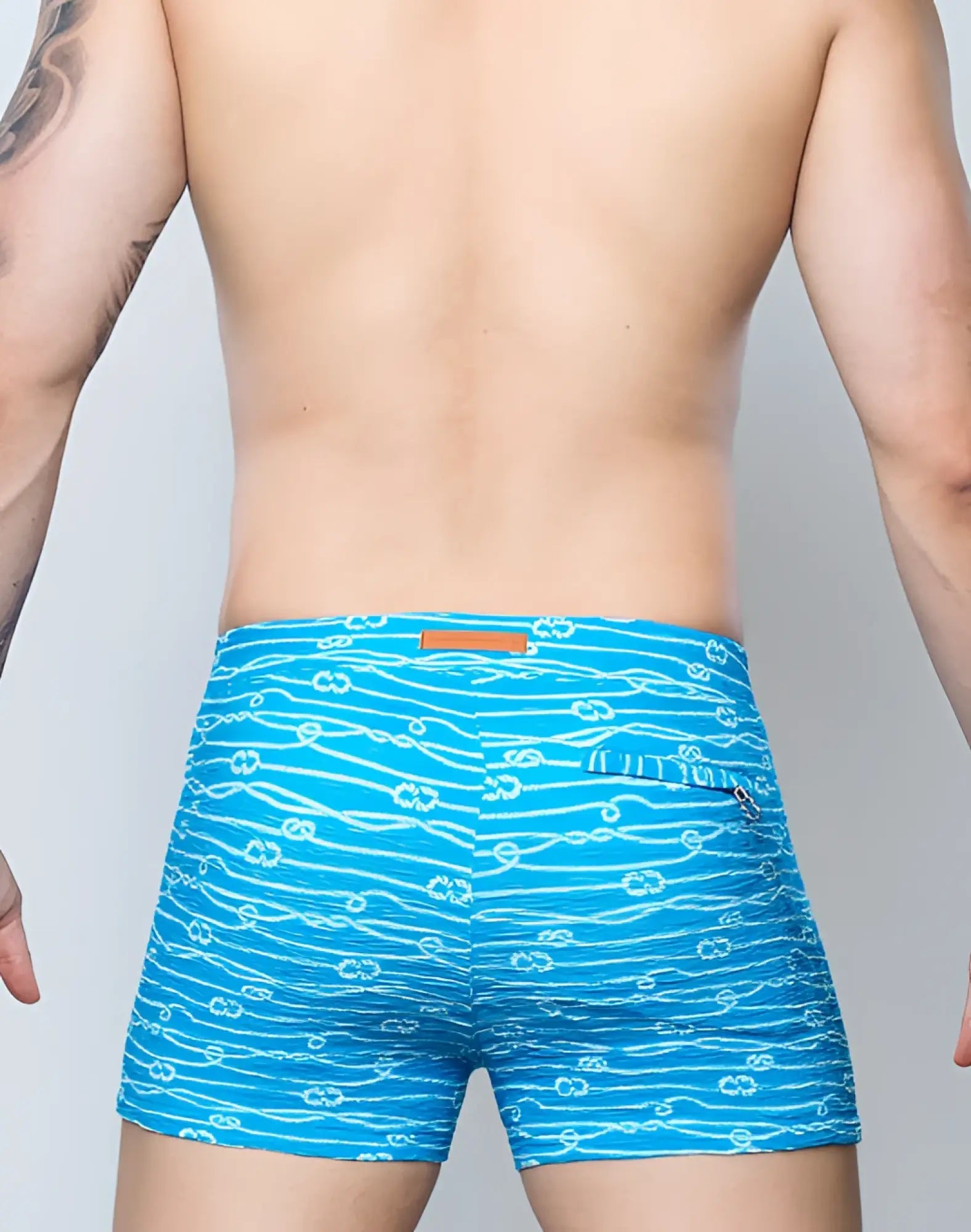 Bright blue 2EROS v60 swim trunks with white rope and anchor print designed for men’s beachwear