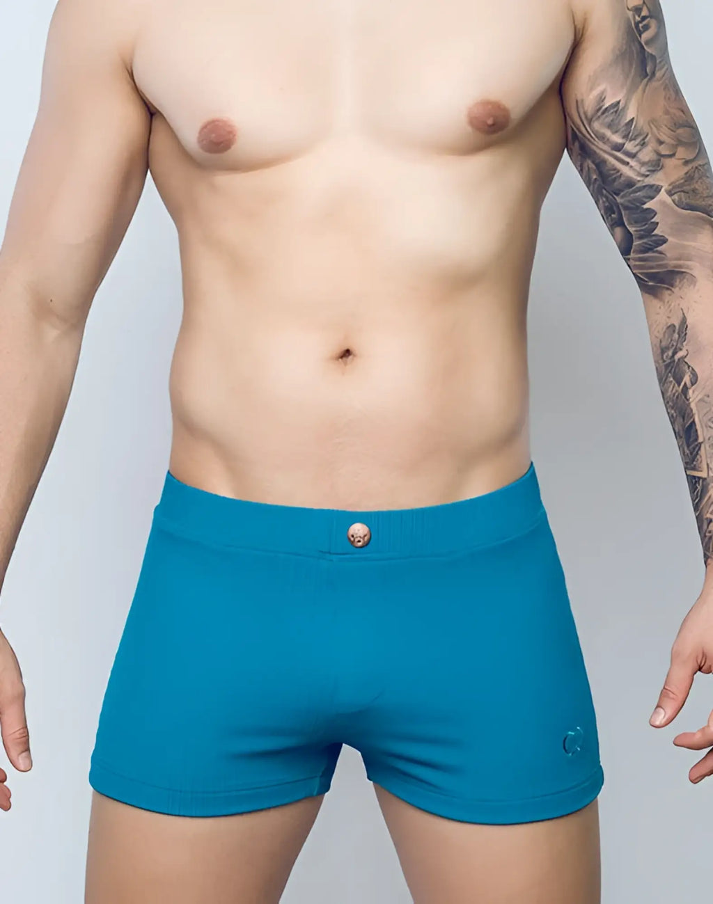 Teal ribbed men’s briefs with skull button and subtle logo on the side from 2EROS V60 swim trunks railroad teal collection