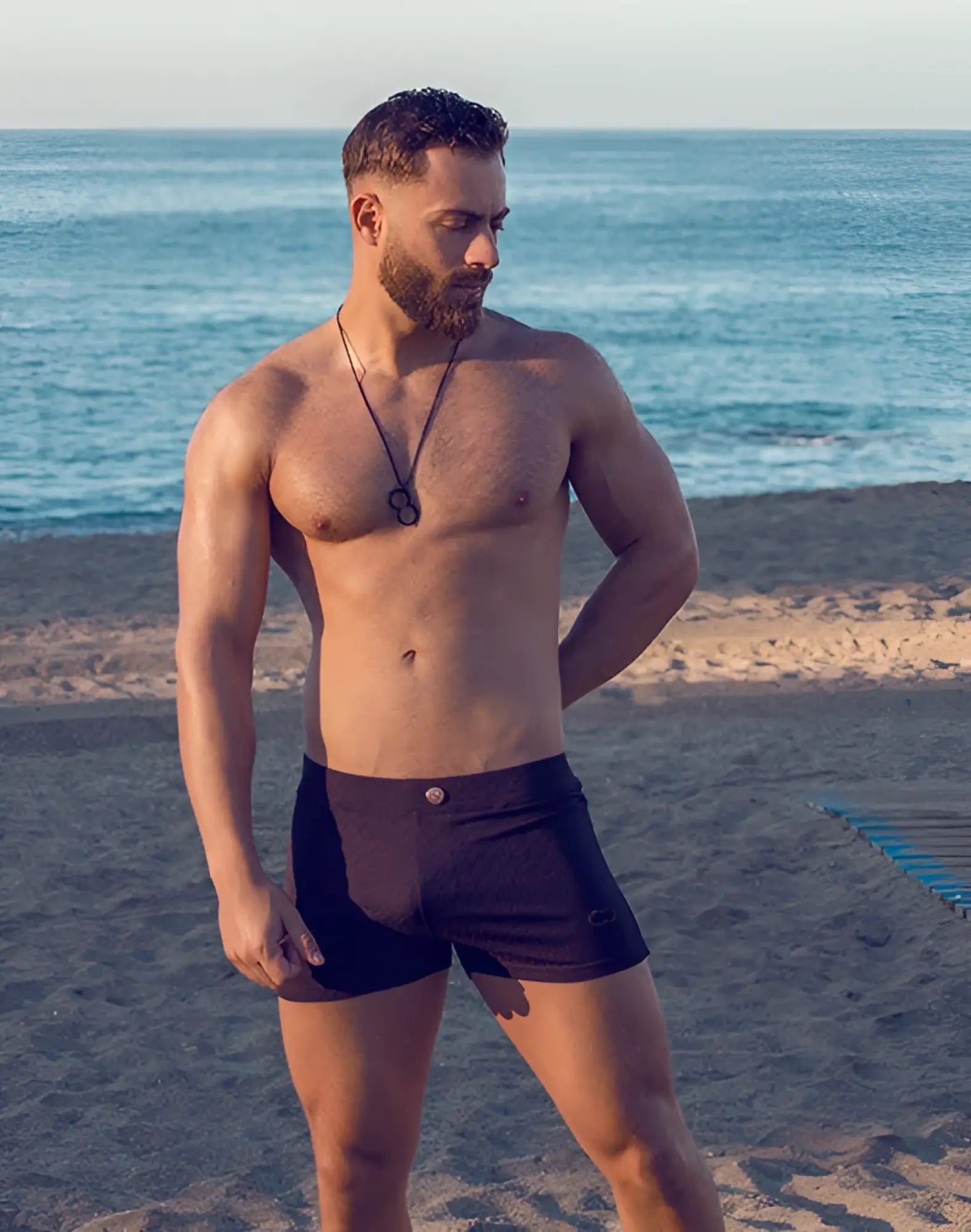 Black textured 2EROS V60 swim trunks with a small metallic button at the waistband in Signet Black color