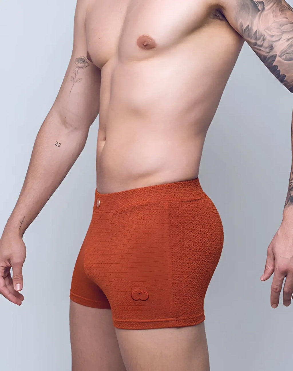 2eros v60 textured swim trunk in signet carmine orange with subtle pattern and small logo on lower right leg