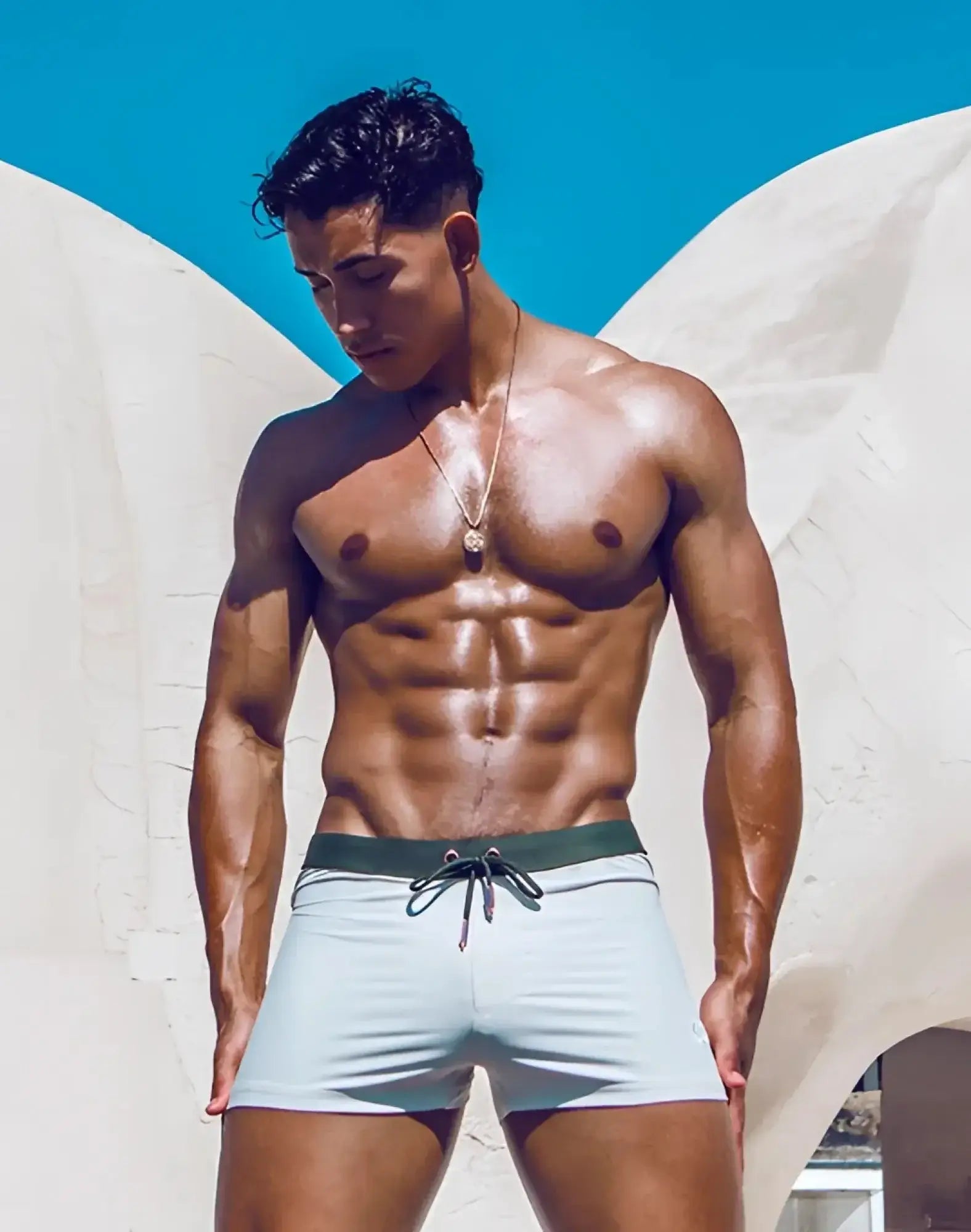 Light blue 2EROS V65 swim trunks with dark green drawstring waistband designed for comfortable beachwear