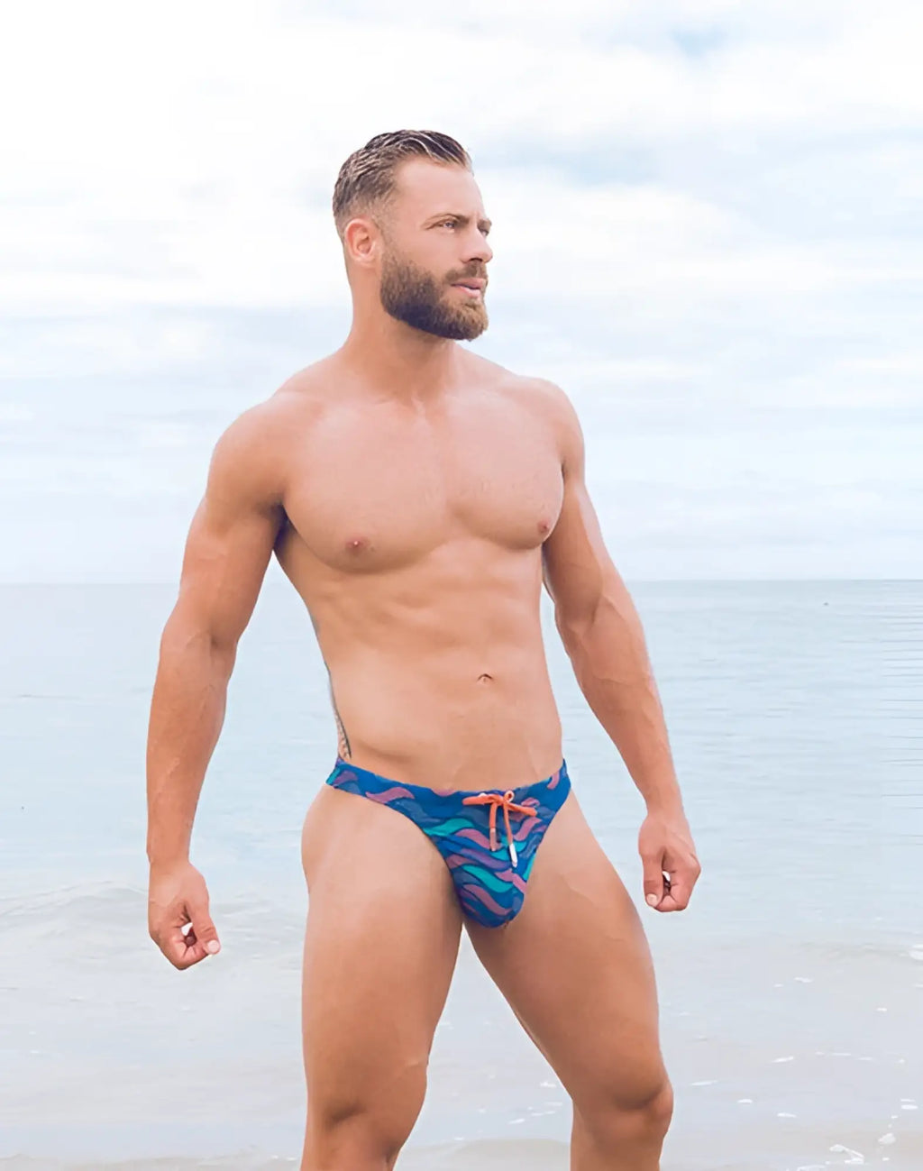 2EROS V80 print swim thong in ocean blue with vibrant tropical pattern and orange drawstring for beachwear