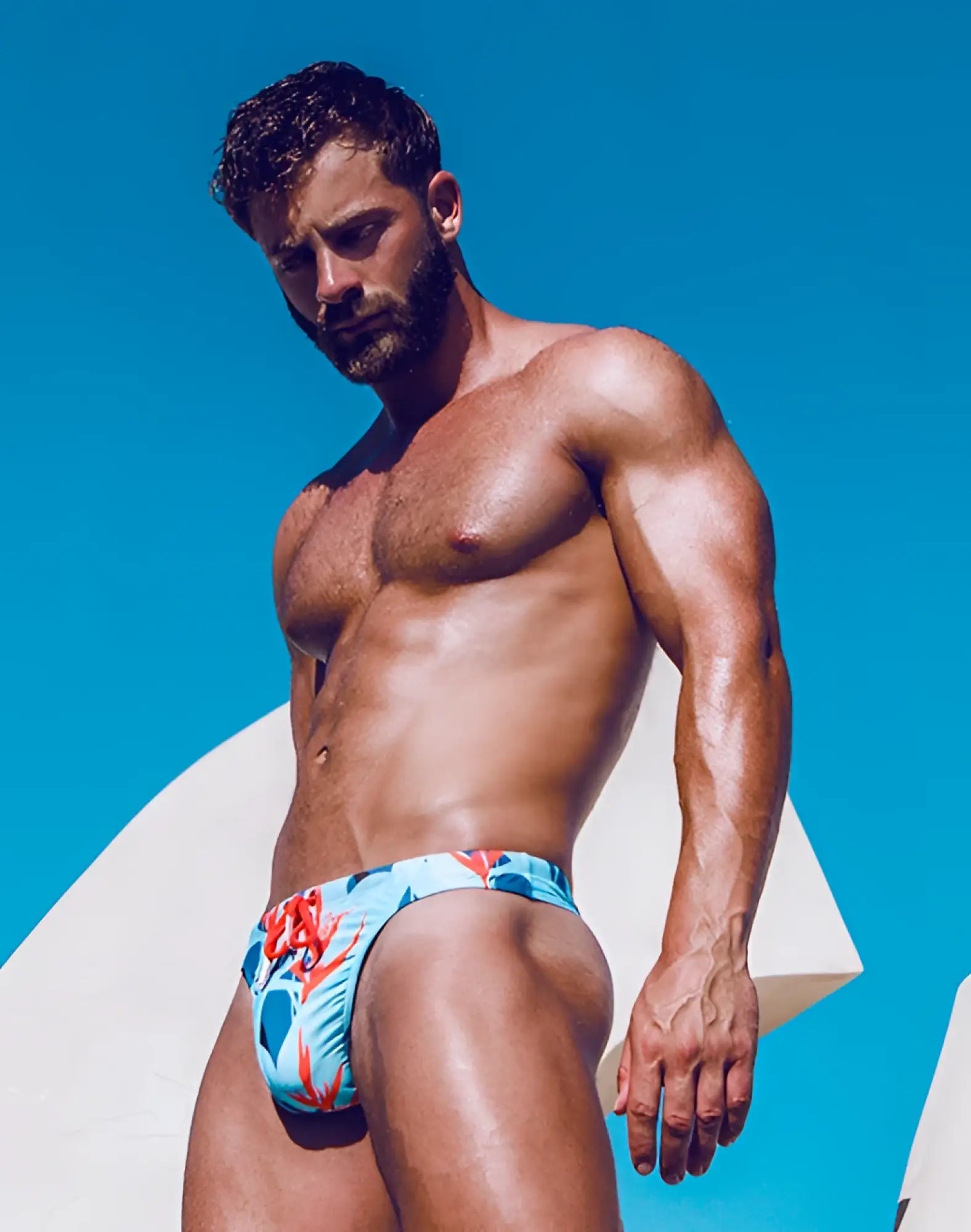 Men’s 2eros v80 print thong in light blue coral red and teal with bold tropical floral pattern for swimwear