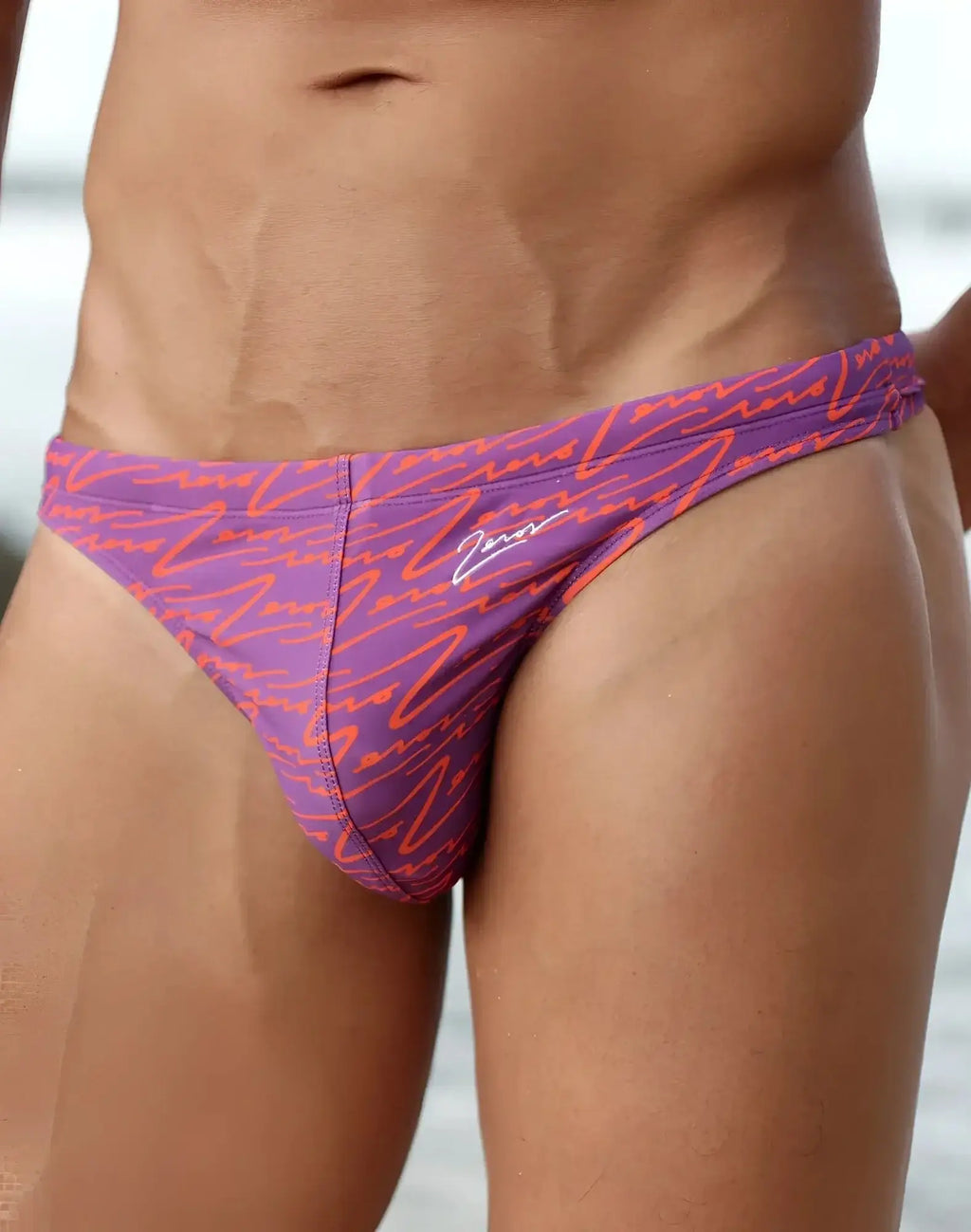 Purple and orange patterned 2EROS V80 printed swim thong with signature logo on the side for beachwear