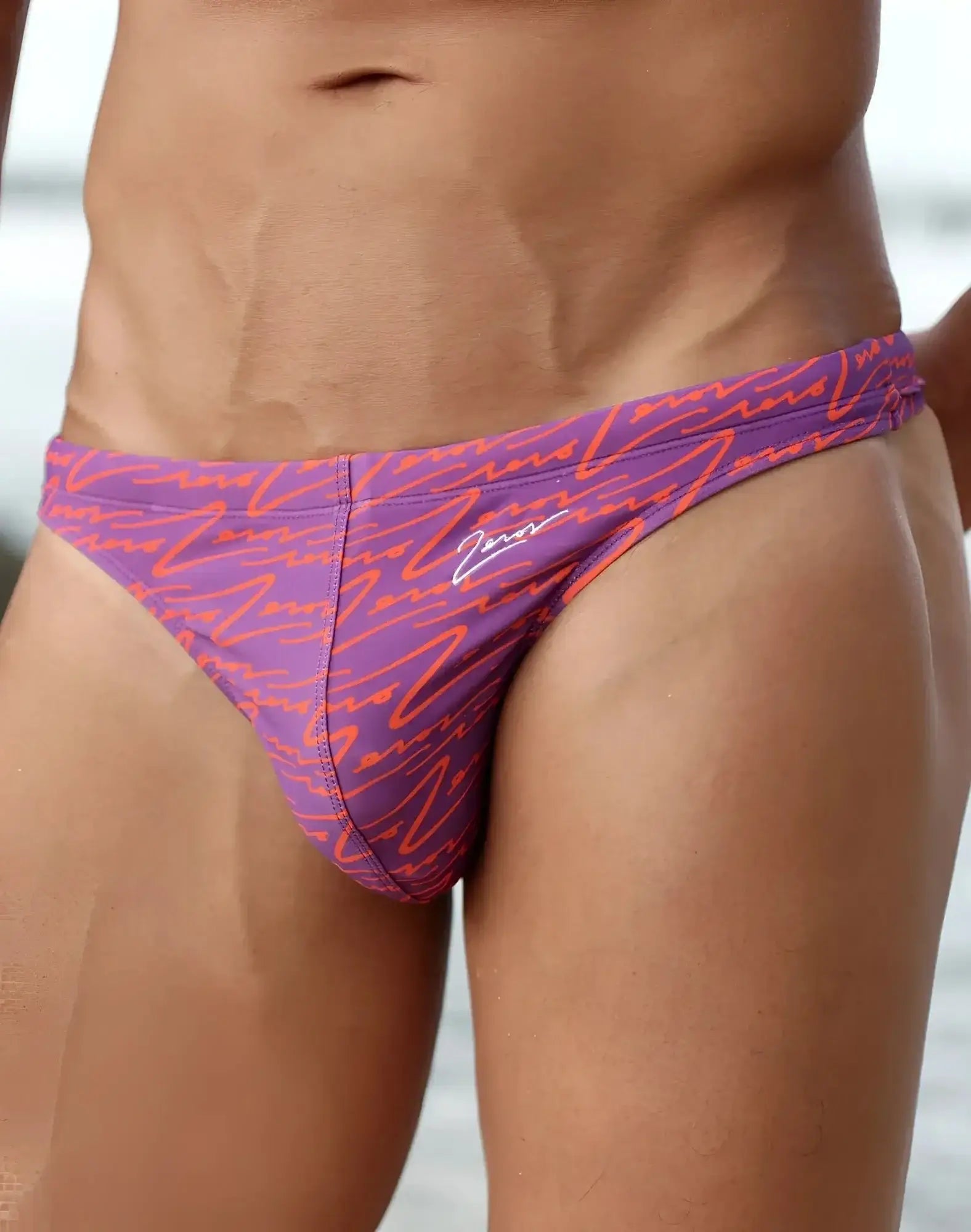Purple and orange patterned 2EROS V80 printed swim thong with signature logo on the side for beachwear