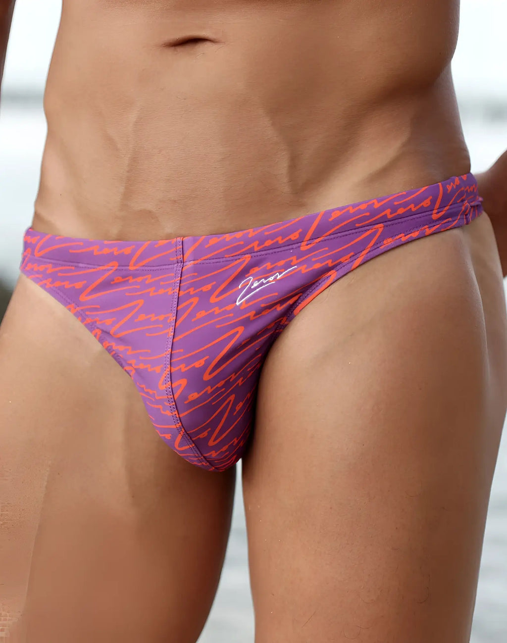 Purple and orange patterned 2EROS V80 printed swim thong with signature logo on the side for beachwear