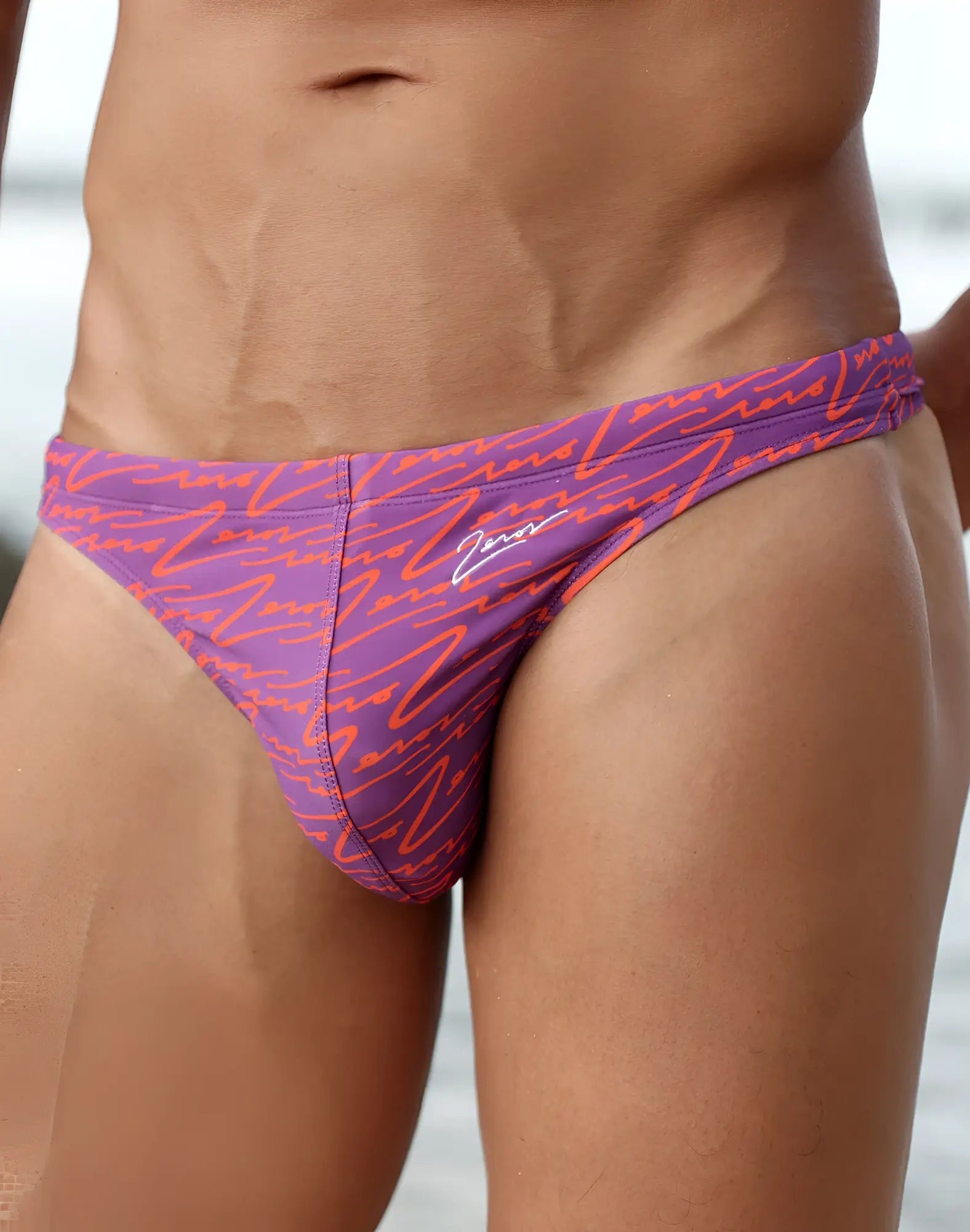 Purple and orange patterned 2EROS V80 printed swim thong with signature logo on the side for beachwear