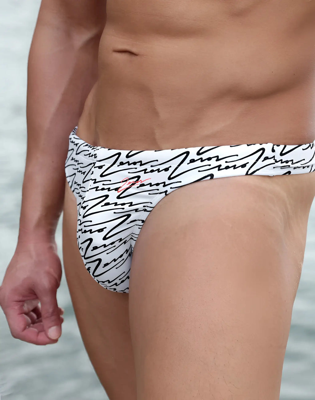 White 2EROS V80 swim thong with black abstract lines and a small red logo on the side for beachwear