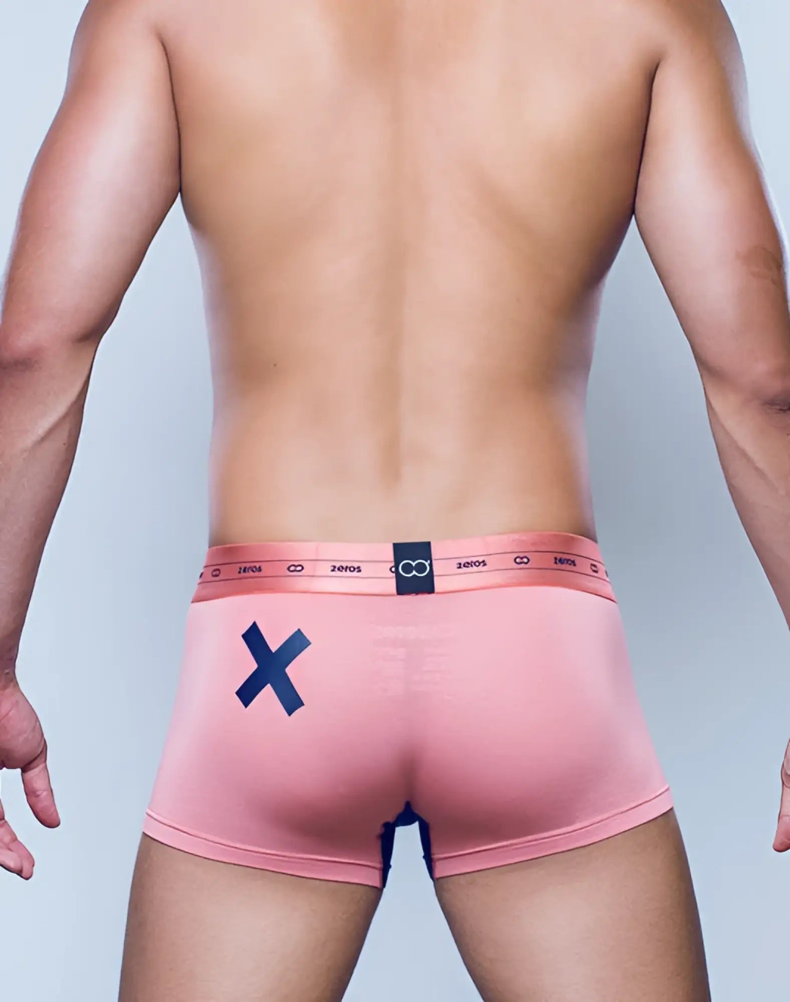 Back side of 2eros x-series trunk underwear in rose gold pink with navy x and elastic waistband with 20105 text and logo