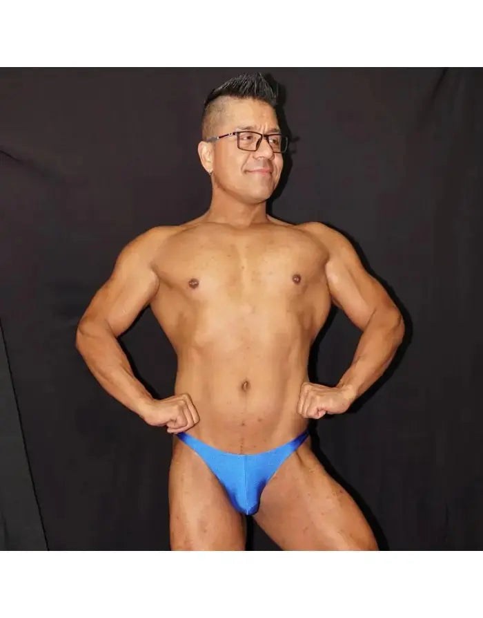 Blue bikini jockstrap underwear made of soft material showcased by a model with a muscular build by Arroyman.